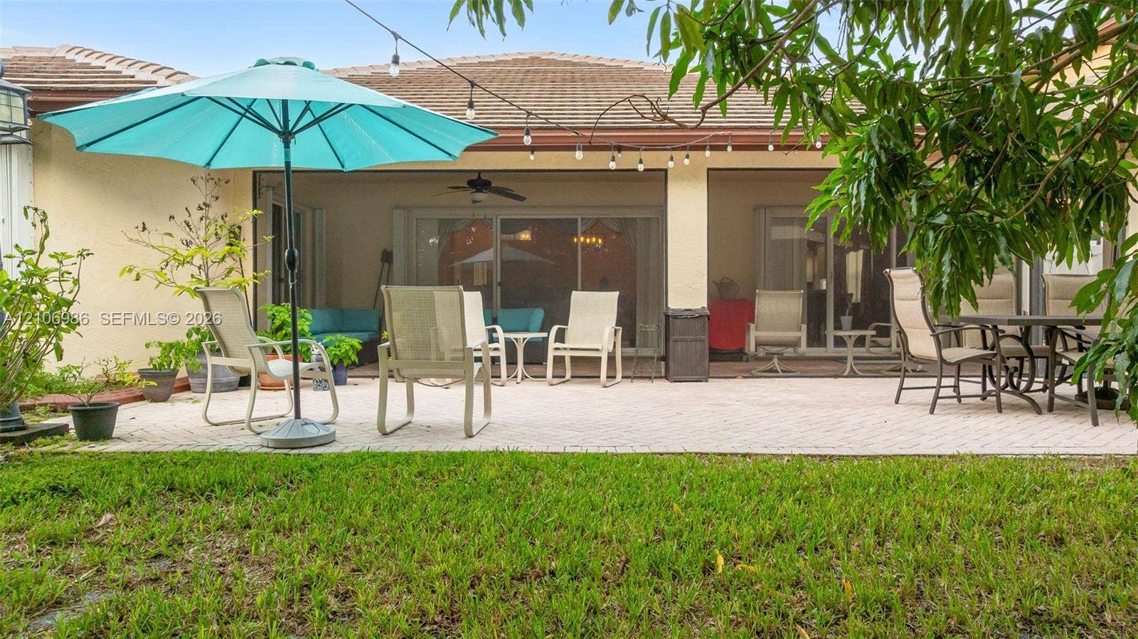 3801 SW 147th Avenue, Miramar, FL 33027 Paver patio with a covered lanai featuring a ceiling fan and sliding glass door access