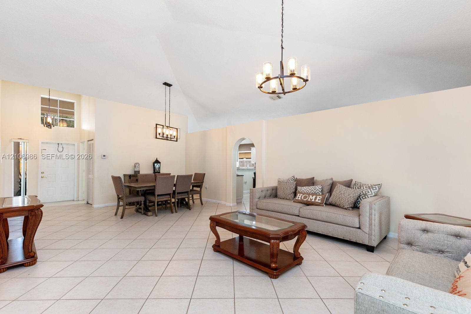 3801 SW 147th Avenue, Miramar, FL 33027 Vaulted ceilings, large-format tile flooring, arched wall pass-through, and dual tiered lighting fixtures