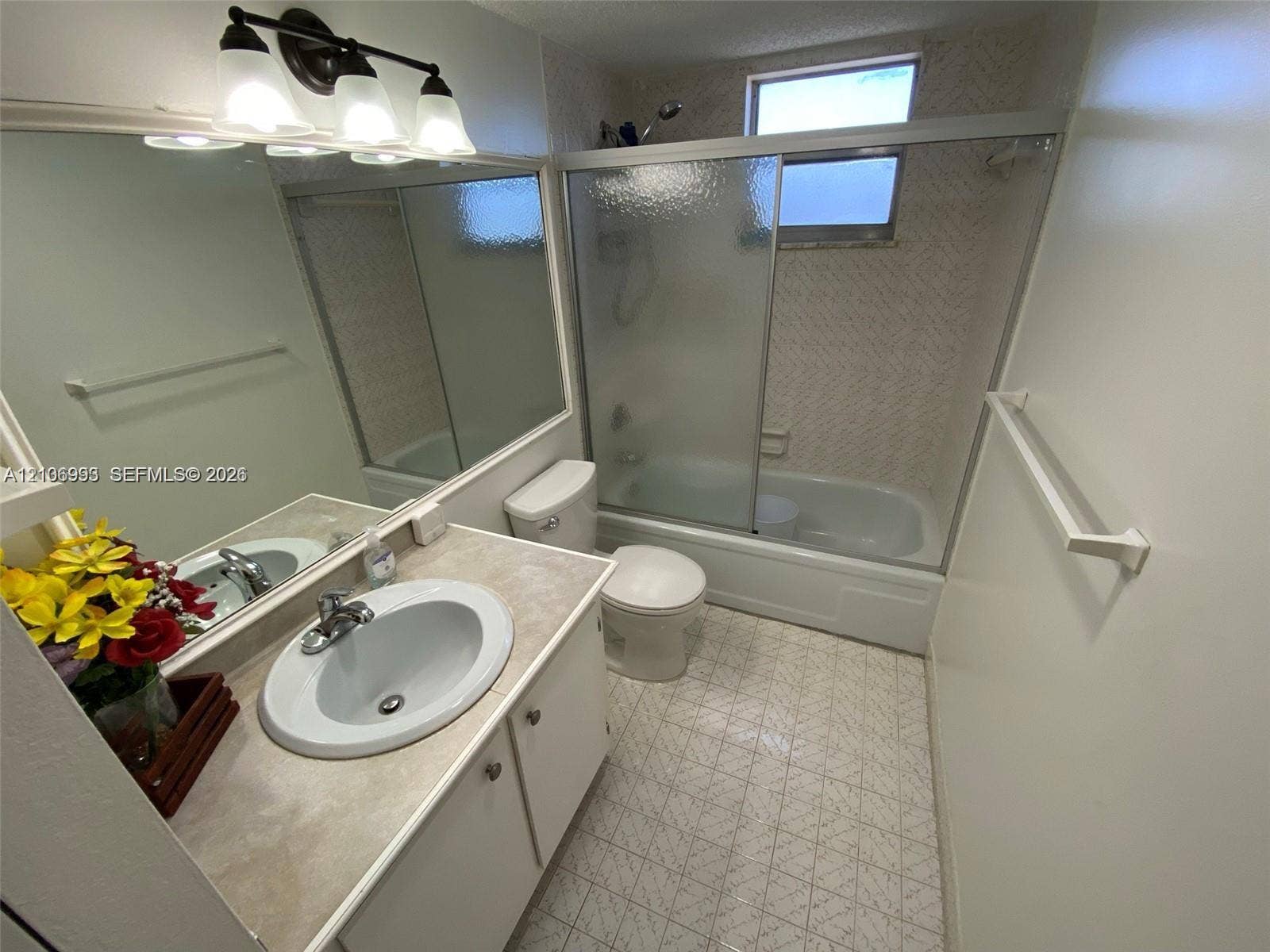 410 NW 68th Avenue, #515, Plantation, Plantation, FL 33317 Bathroom featuring a vanity with a drop-in sink, a large wall-mounted mirror, a tub-shower combination with sliding glass doors, and tiled flooring