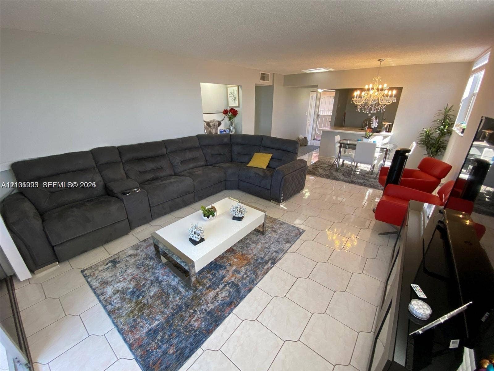 410 NW 68th Avenue, #515, Plantation, Plantation, FL 33317 Open-concept interior featuring light-toned tile flooring, recessed ceiling lighting, and a chandelier-style fixture
