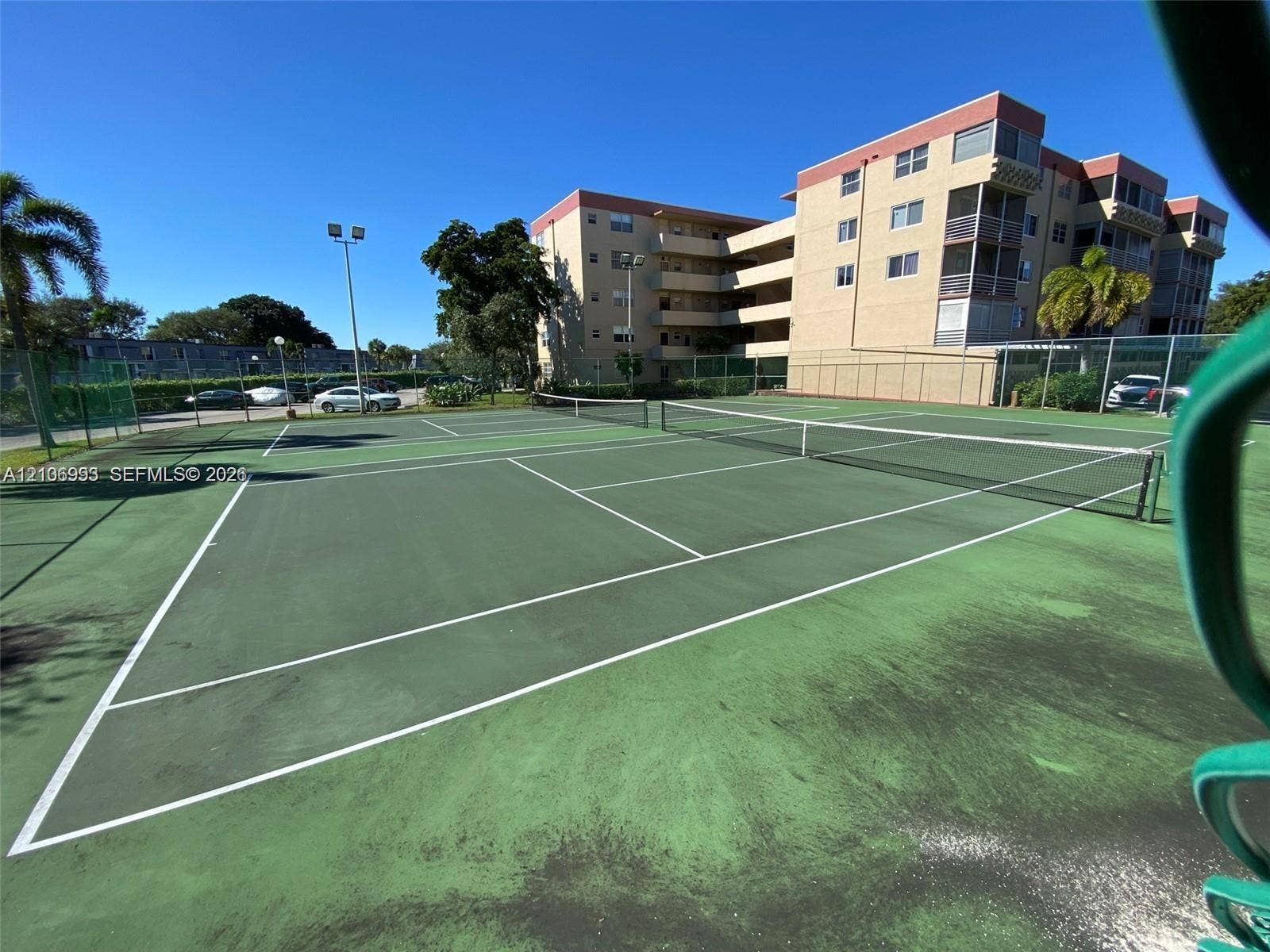 410 NW 68th Avenue, #515, Plantation, Plantation, FL 33317 Tennis court featuring a hard surface, perimeter fencing, and dual net systems