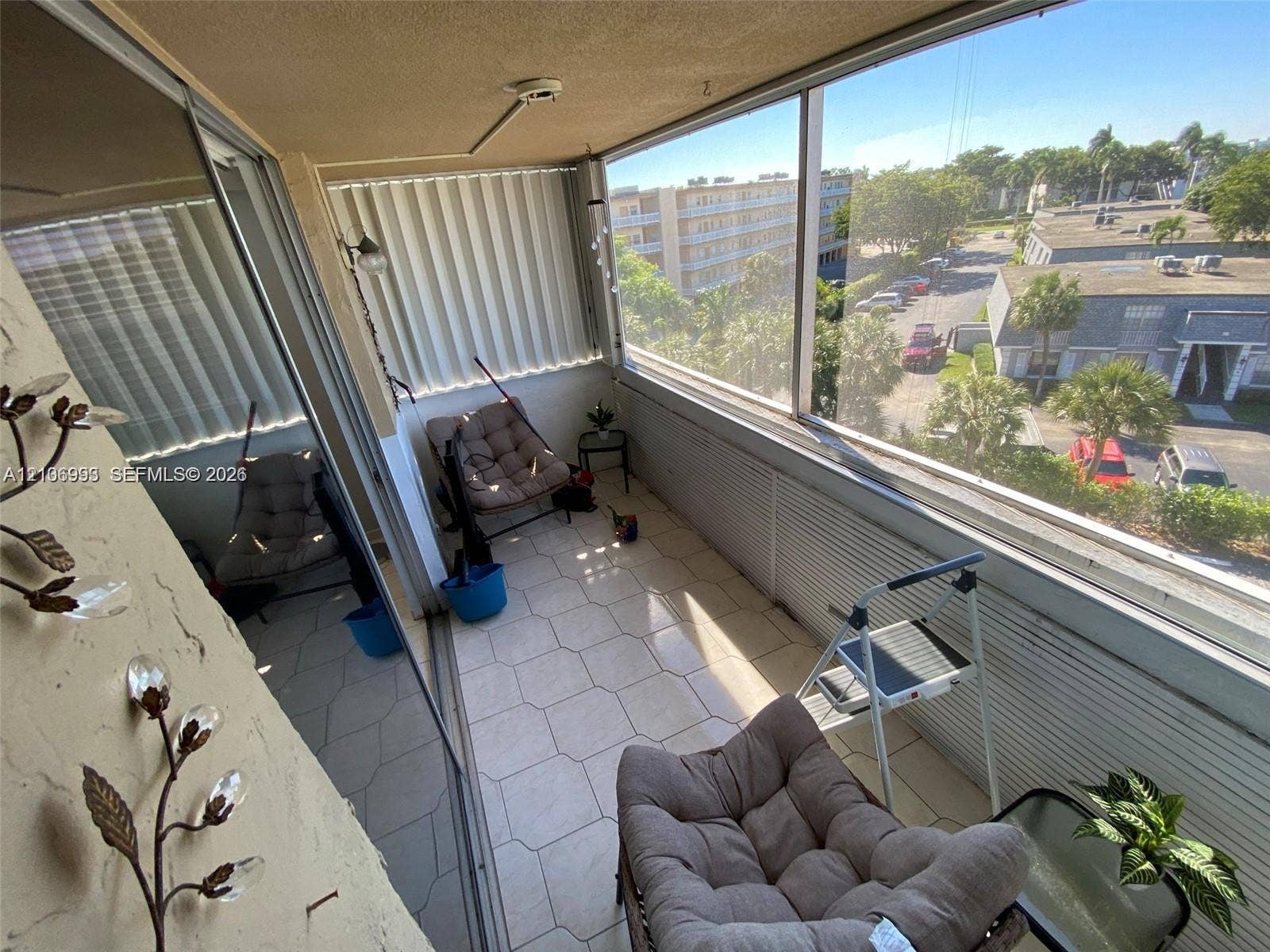 410 NW 68th Avenue, #515, Plantation, Plantation, FL 33317 Enclosed balcony featuring tile flooring, floor-to-ceiling glass paneling, and sliding windows