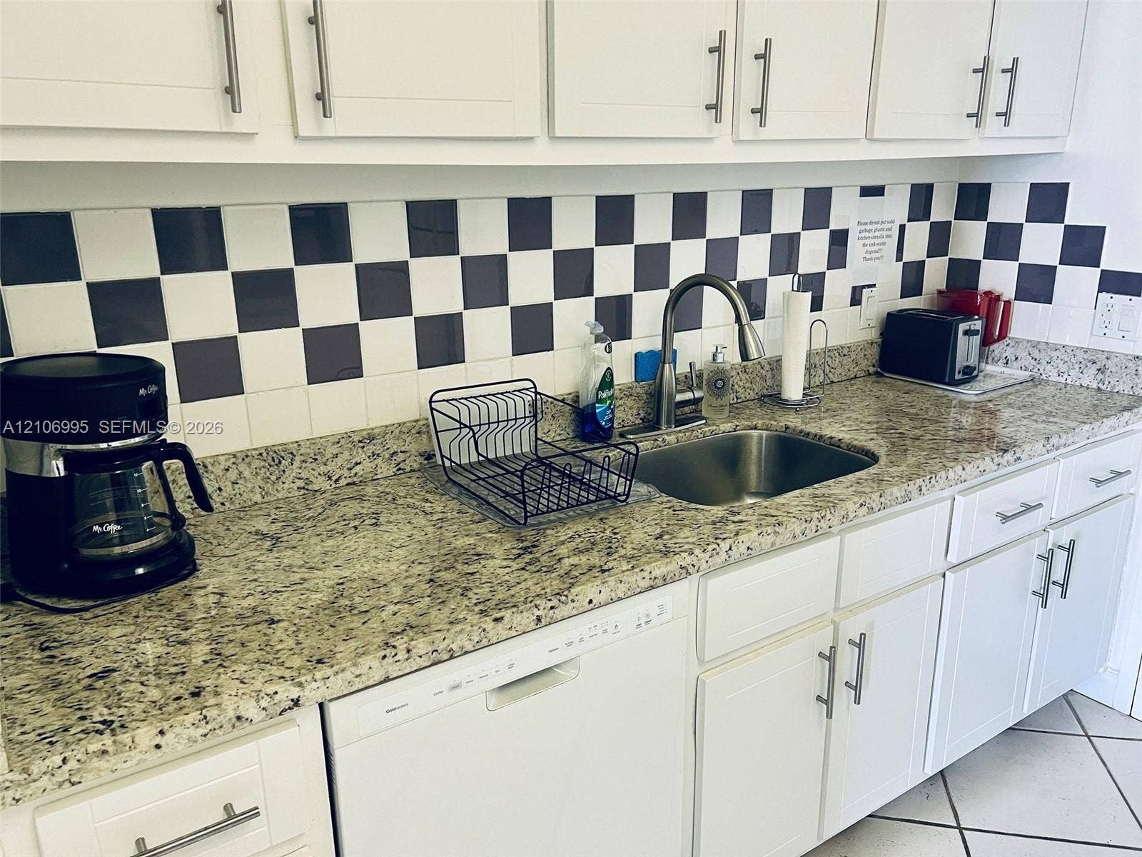 3505 S Ocean Drive, #1404, Hollywood, FL 33019 Kitchen featuring stone countertops, shaker-style white cabinetry with brushed-metal pulls, a stainless steel undermount sink, and a high-arch pull-down faucet
