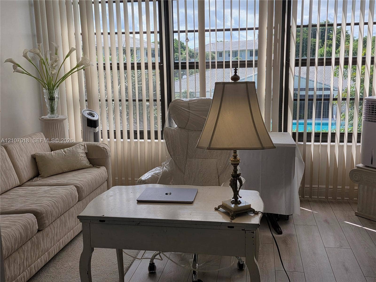 3716 Whitehall Drive, #304, West Palm Beach, West Palm Beach, FL 33401 Floor-to-ceiling windows featuring vertical blinds and light-toned wood-finish flooring