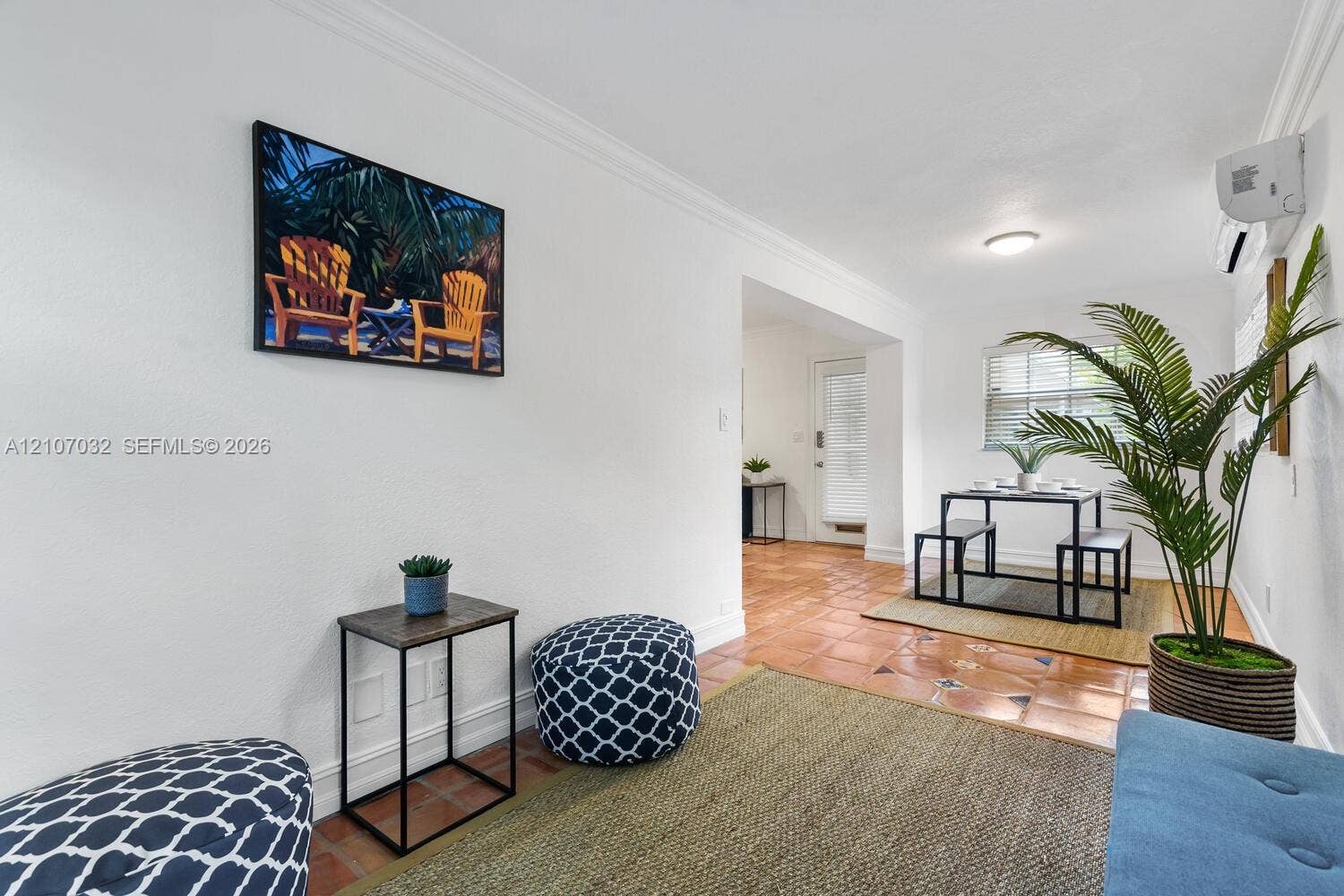 443 NE 17th Way, Fort Lauderdale, FL 33301 Interior space featuring ceramic tile flooring, crown molding, and wall-mounted climate control unit
