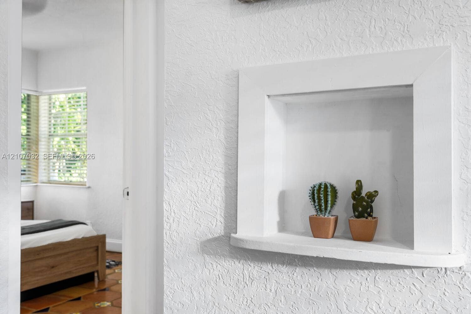 Built-in wall niche with a curved shelf and textured wall finish