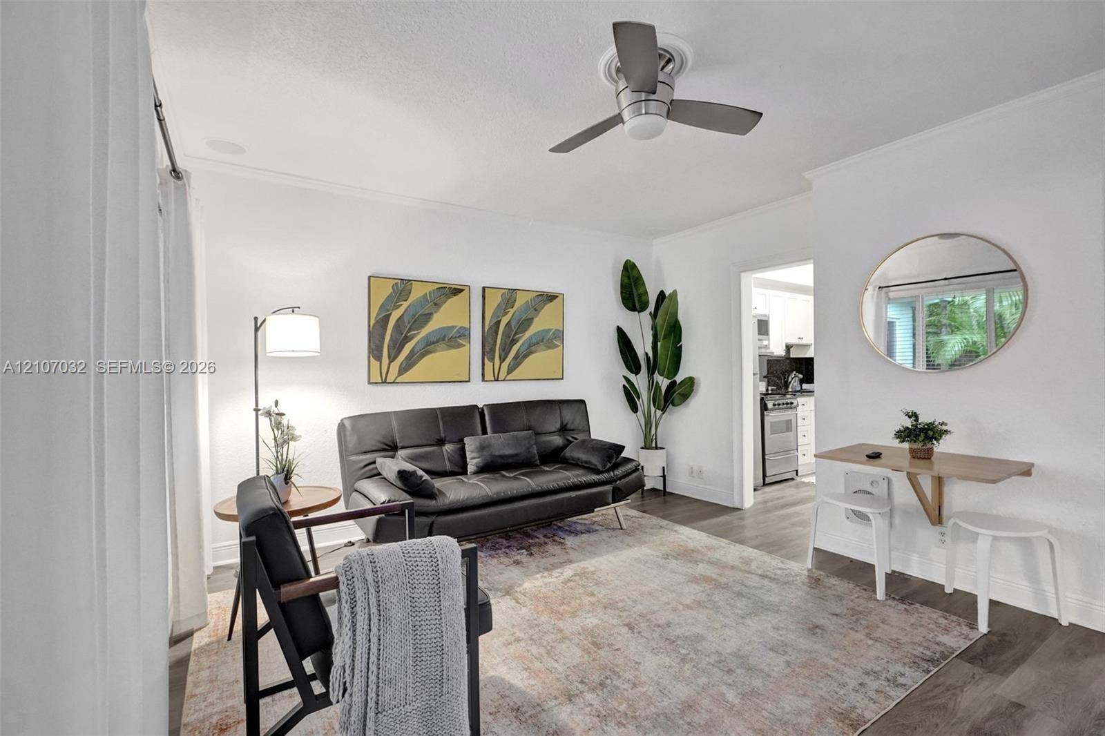 443 NE 17th Way, Fort Lauderdale, FL 33301 Living area featuring wood-finish flooring, a neutral color palette, and a modern ceiling fan with integrated lighting