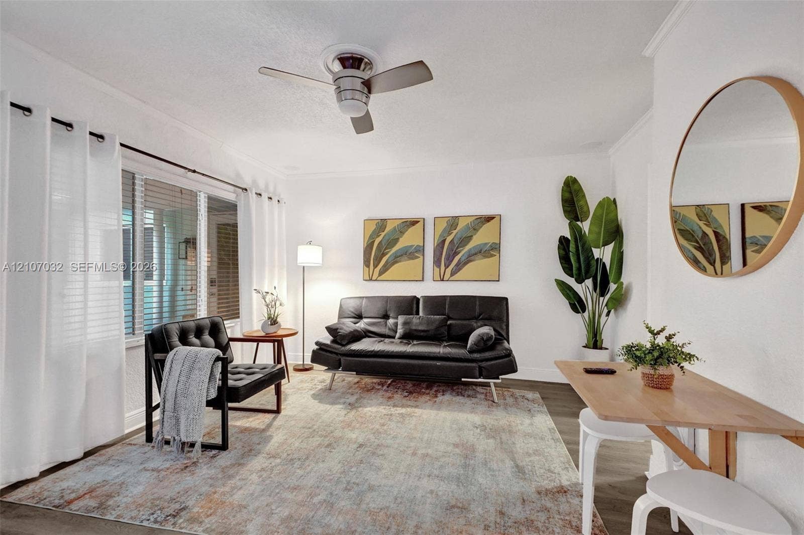 443 NE 17th Way, Fort Lauderdale, FL 33301 Living area featuring neutral wall paint, wood-finish flooring, crown molding, and a modern ceiling fan