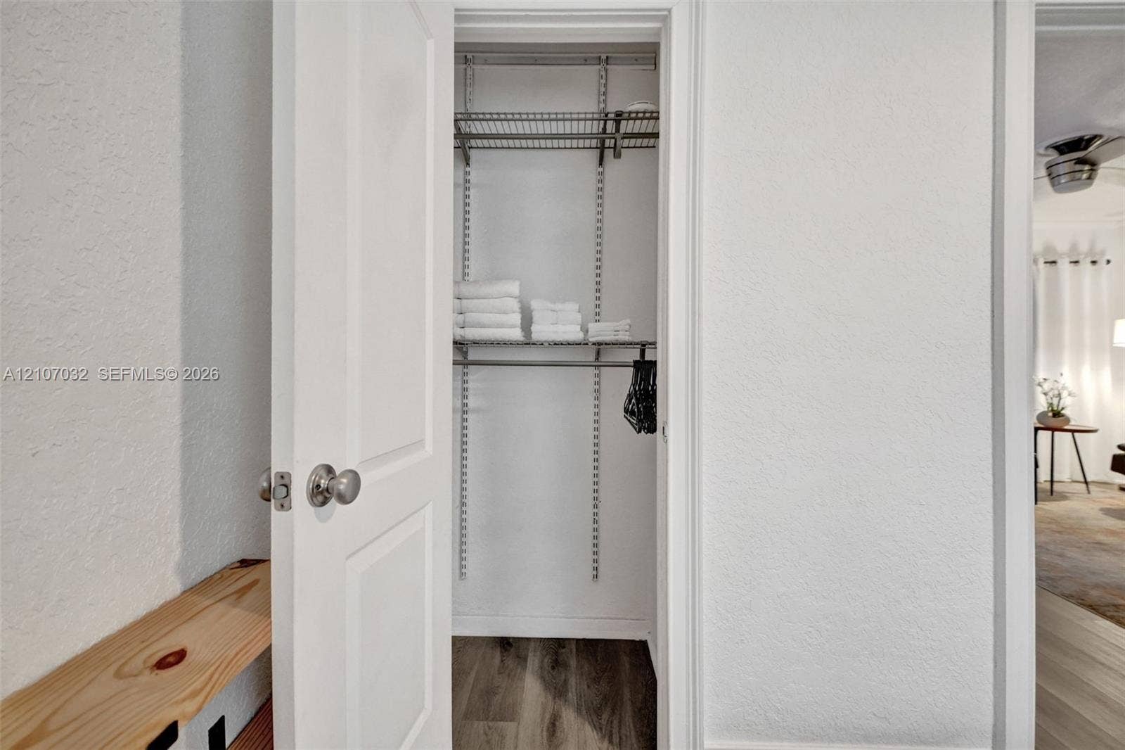 443 NE 17th Way, Fort Lauderdale, FL 33301 Reach-in closet featuring adjustable metal shelving and wood-finish flooring