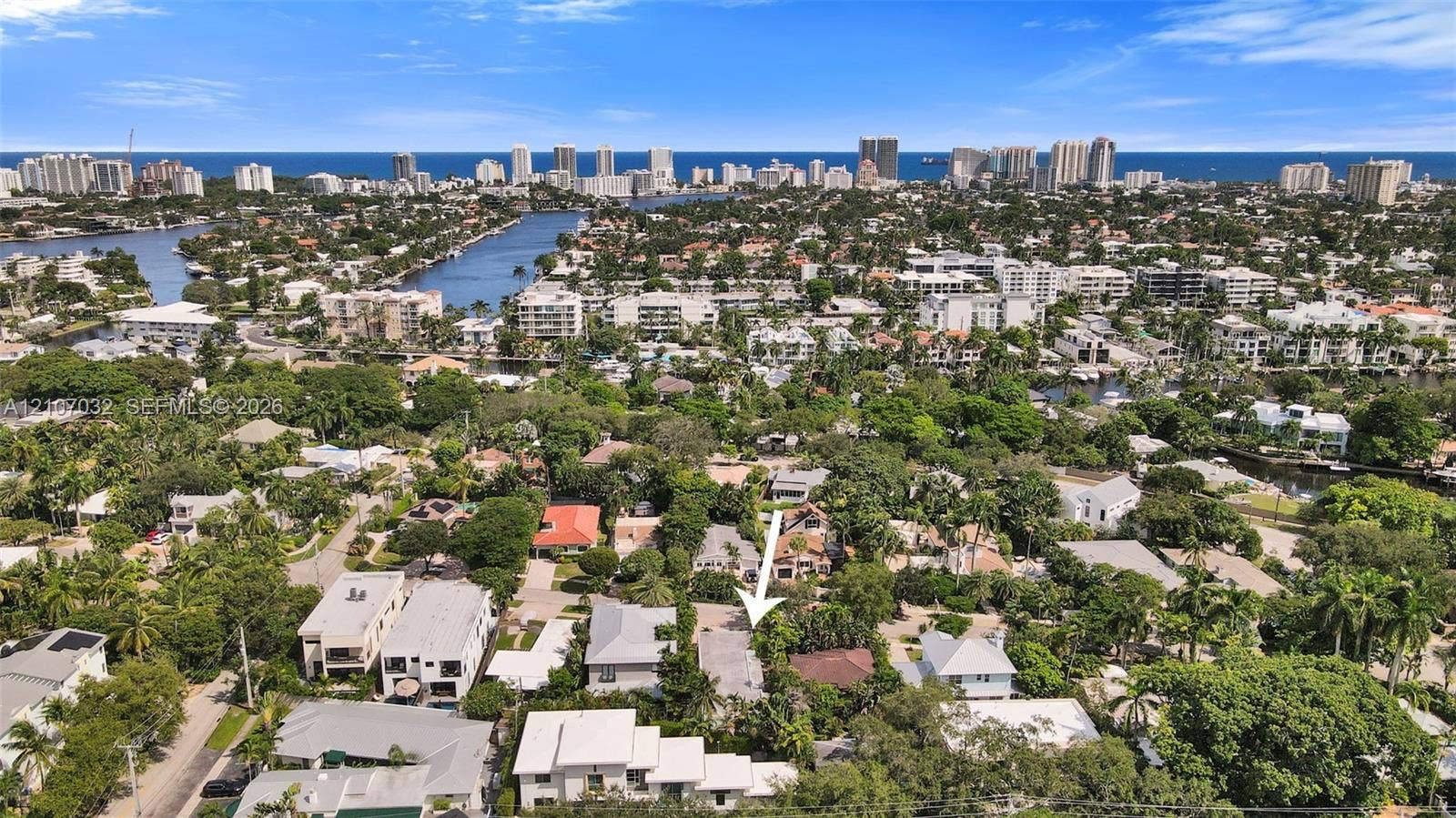 443 NE 17th Way, Fort Lauderdale, FL 33301 Aerial perspective featuring a residential lot with mature landscaping and proximity to regional waterways and urban coastal infrastructure
