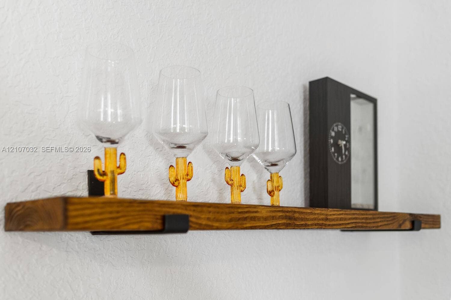443 NE 17th Way, Fort Lauderdale, FL 33301 Wall-mounted floating wood shelf featuring a stained finish and matte black metal support brackets