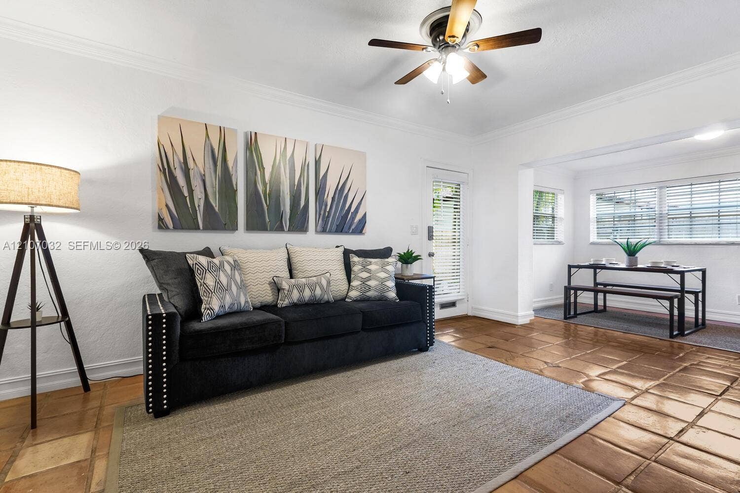 443 NE 17th Way, Fort Lauderdale, FL 33301 Terracotta tile flooring, crown molding, and a multi-light ceiling fan
