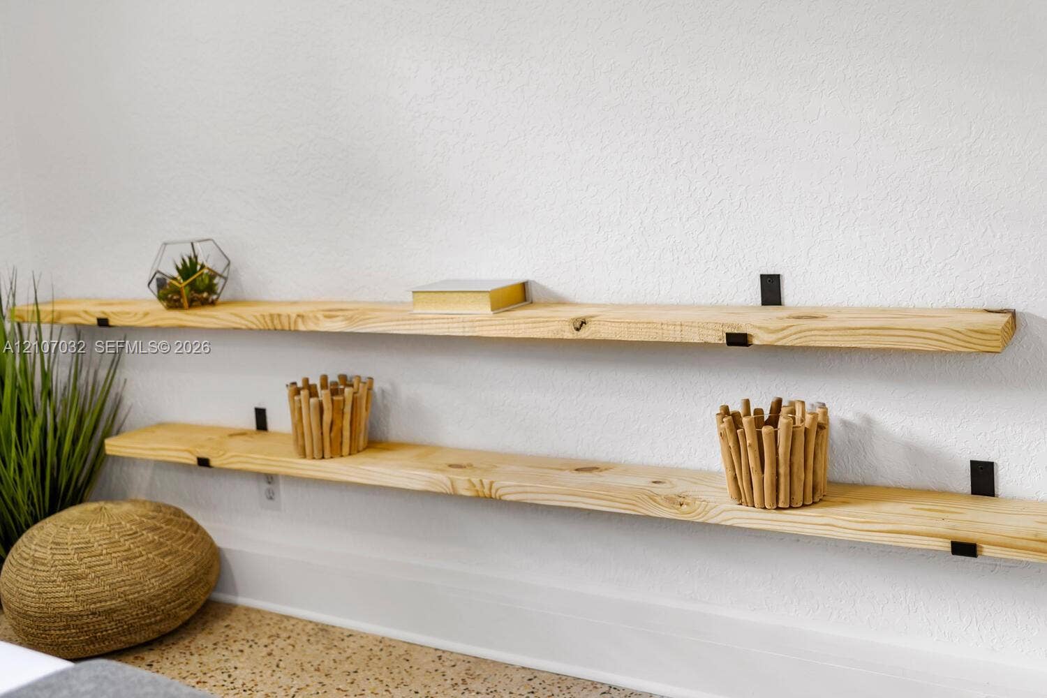 443 NE 17th Way, Fort Lauderdale, FL 33301 Dual natural wood shelving with matte black metal brackets mounted on a white textured wall