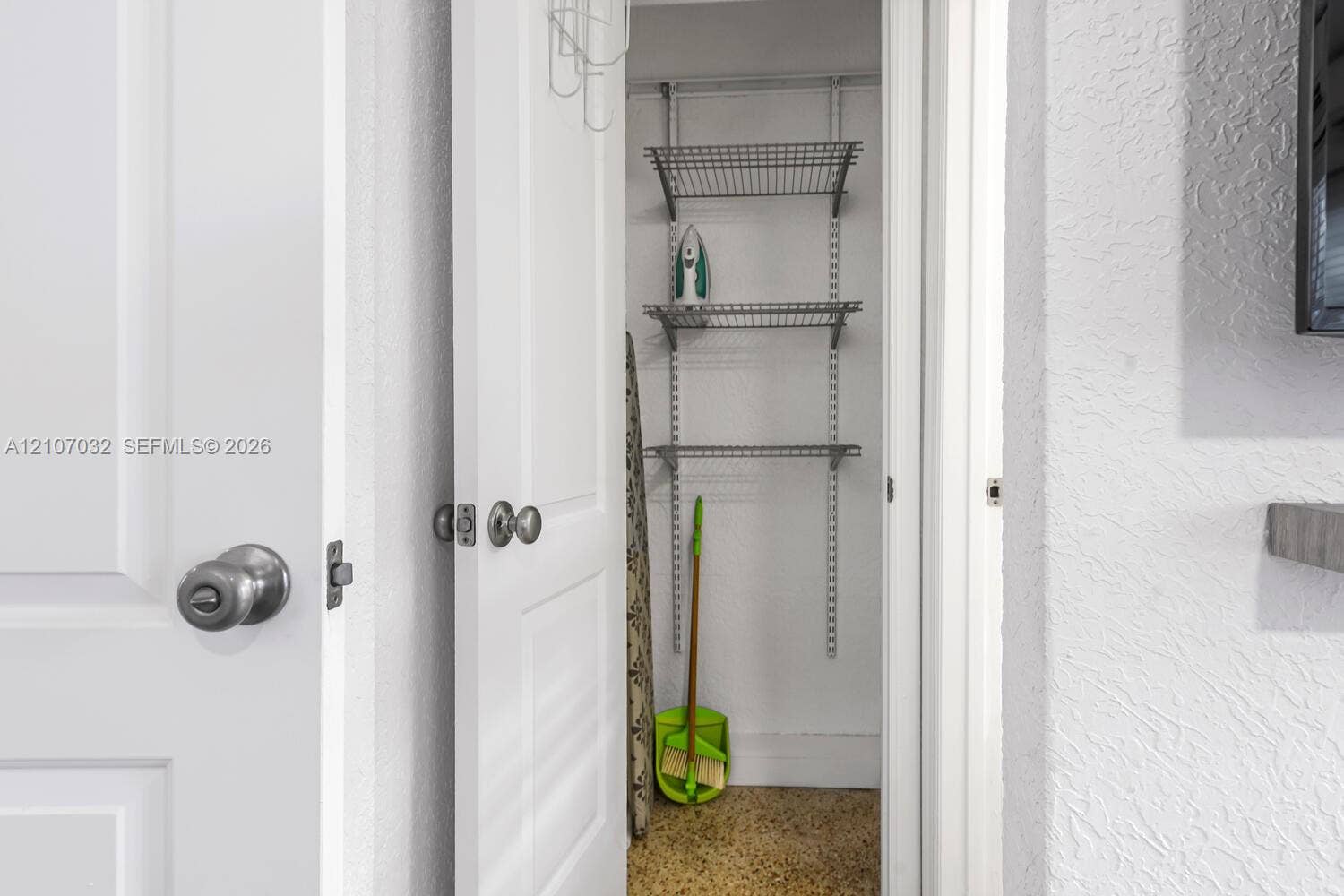 443 NE 17th Way, Fort Lauderdale, FL 33301 Storage closet featuring white paneled interior doors, round polished hardware, and adjustable wire shelving systems
