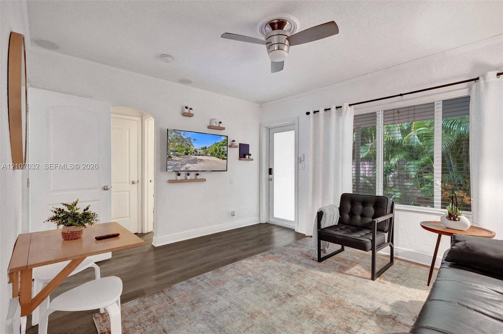 443 NE 17th Way, Fort Lauderdale, FL 33301 Wood-finish flooring, ceiling fan with integrated lighting, multi-panel windows, and recessed ceiling lighting