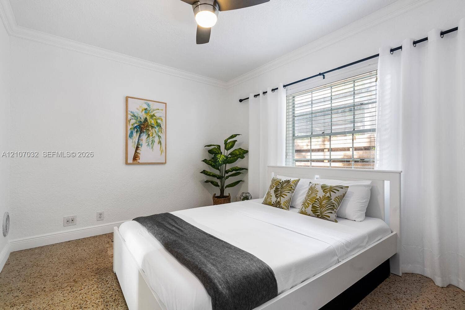 443 NE 17th Way, Fort Lauderdale, FL 33301 Bedroom featuring light-toned interior walls, terrazzo flooring, crown molding, and a ceiling fan with integrated lighting