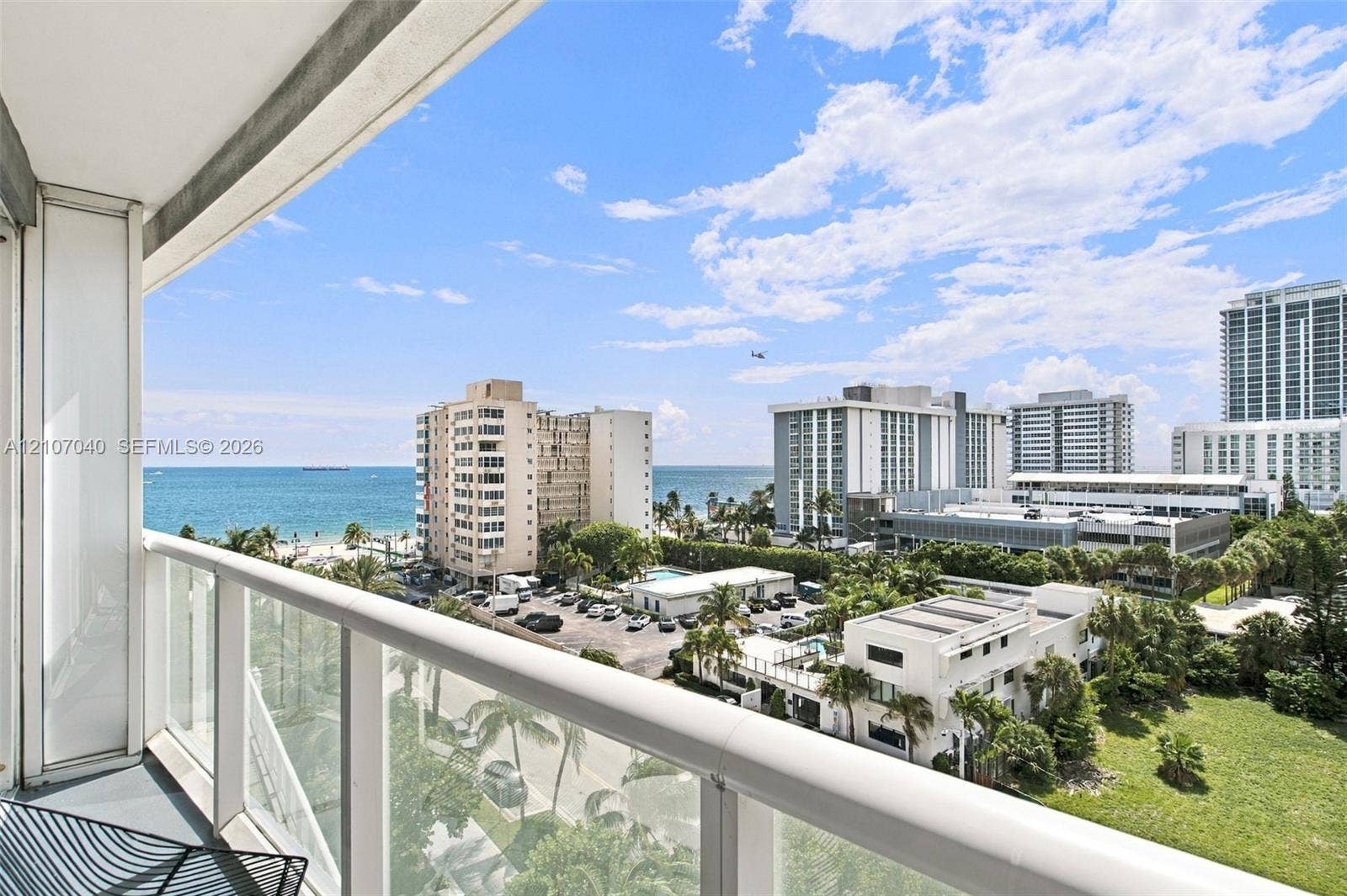 3101 Bayshore Drive, #707, Fort Lauderdale, FL 33304 Covered balcony featuring a glass-panel railing and open ocean horizon