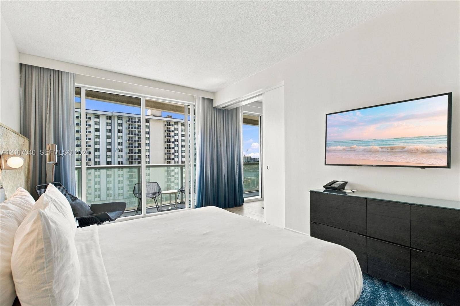 3101 Bayshore Drive, #707, Fort Lauderdale, FL 33304 Floor-to-ceiling glass sliding doors, private balcony access, and crisp white wall finishes