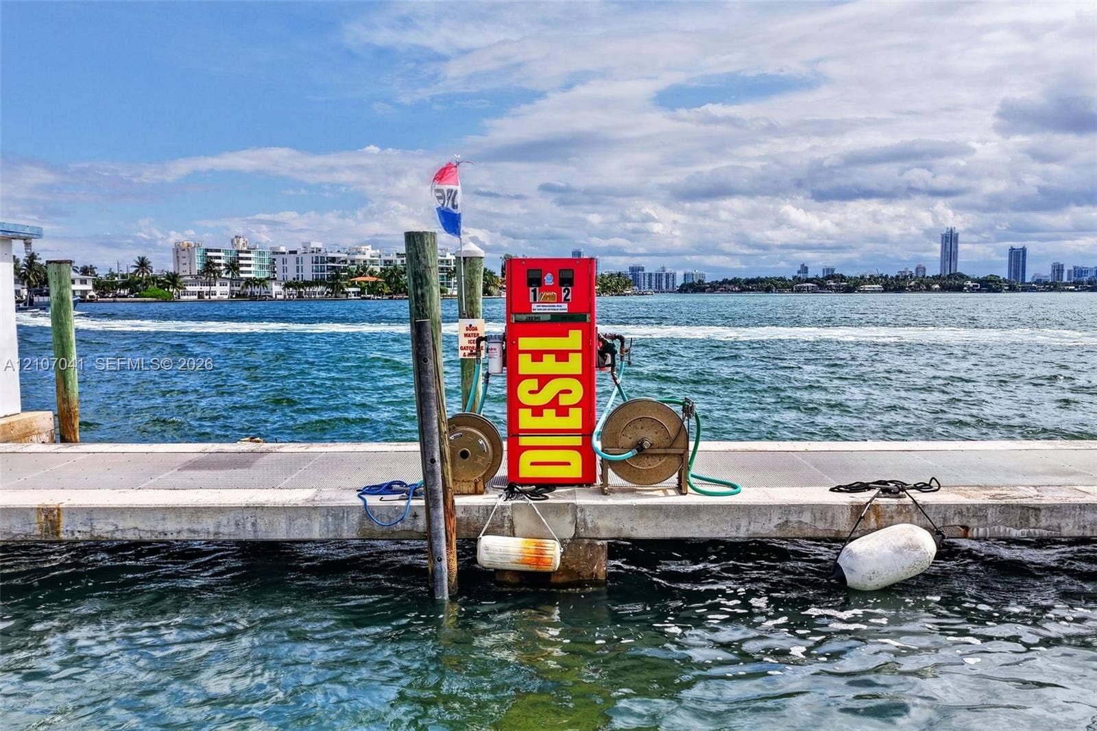Concrete deep-water dock featuring an integrated fuel dispensing station with dual reels and mooring pilings