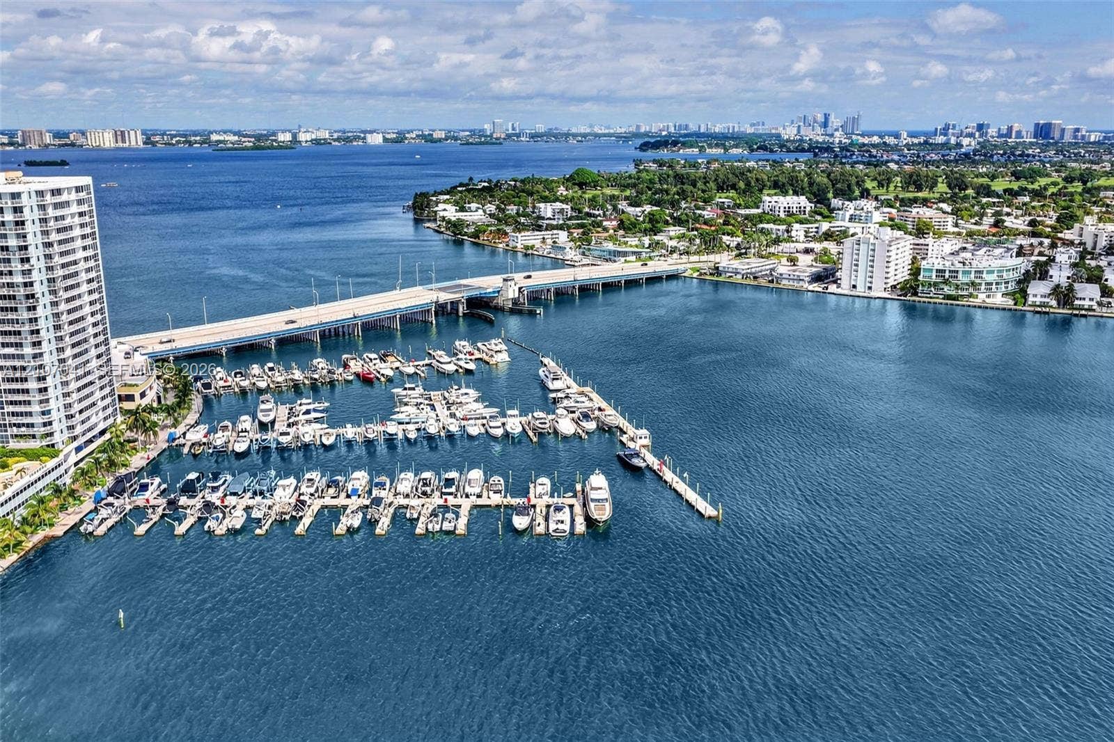 Waterfront property featuring a private deep-water marina with multiple boat slips, situated along a prominent coastal waterway