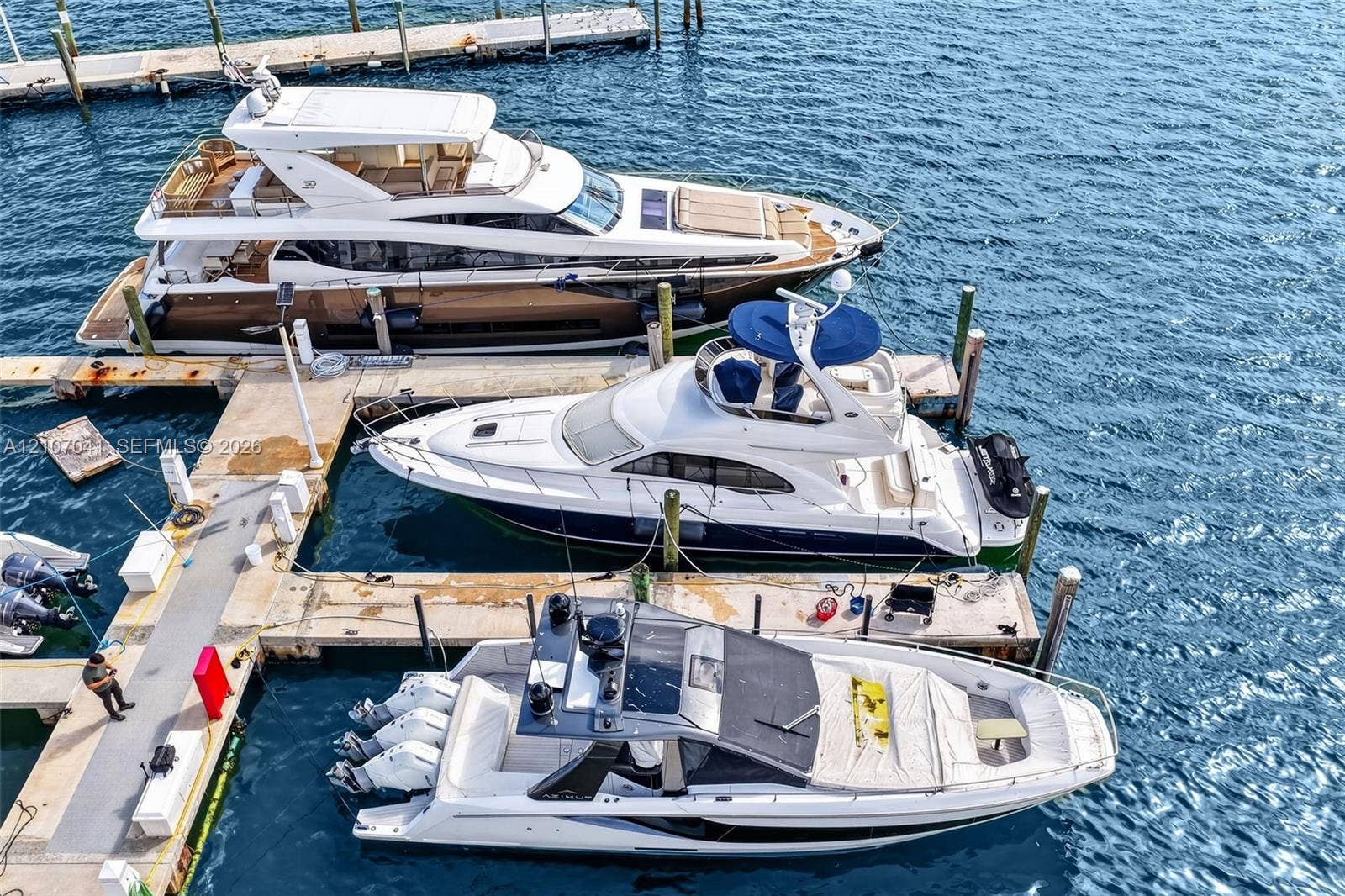 Concrete deep-water docking system featuring fixed pilings and individual slip configurations