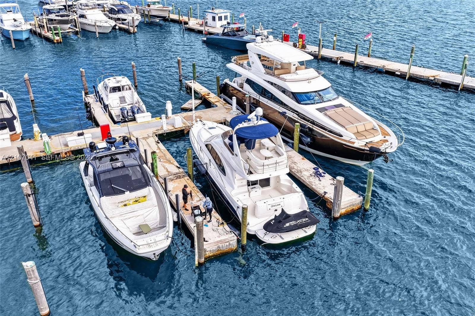Deep-water marina featuring concrete floating docks, multiple dedicated boat slips, and piling supports