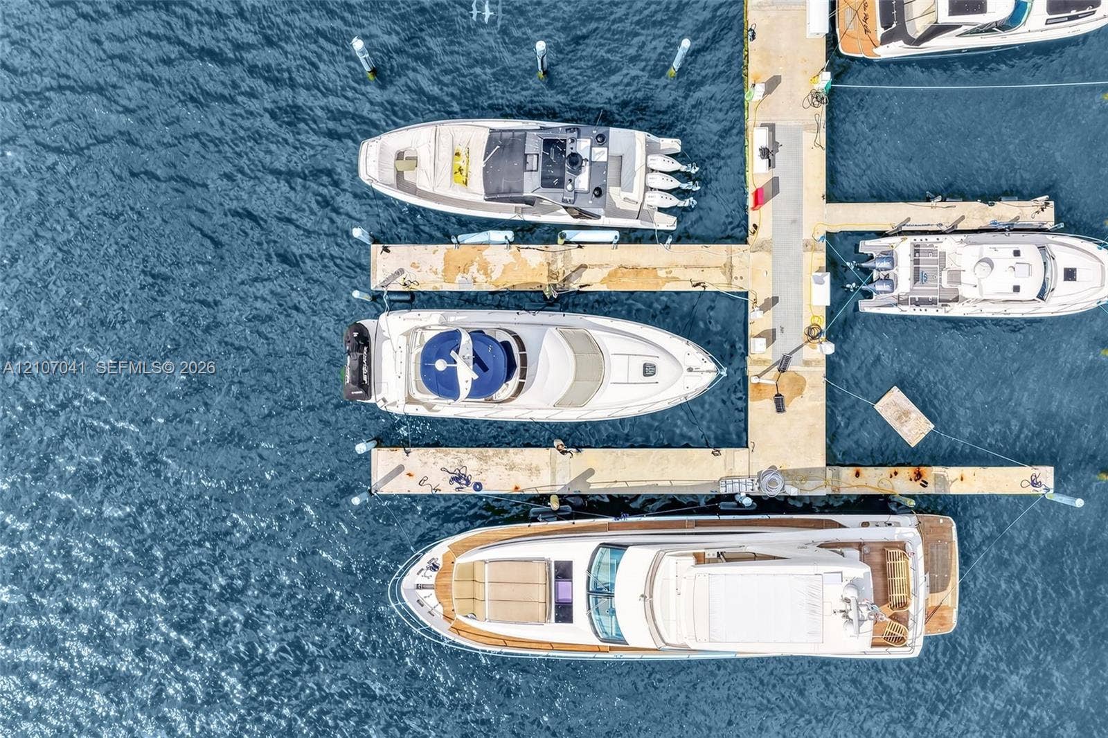 Private deep-water boat slip featuring concrete mooring structure and integrated utility pylons