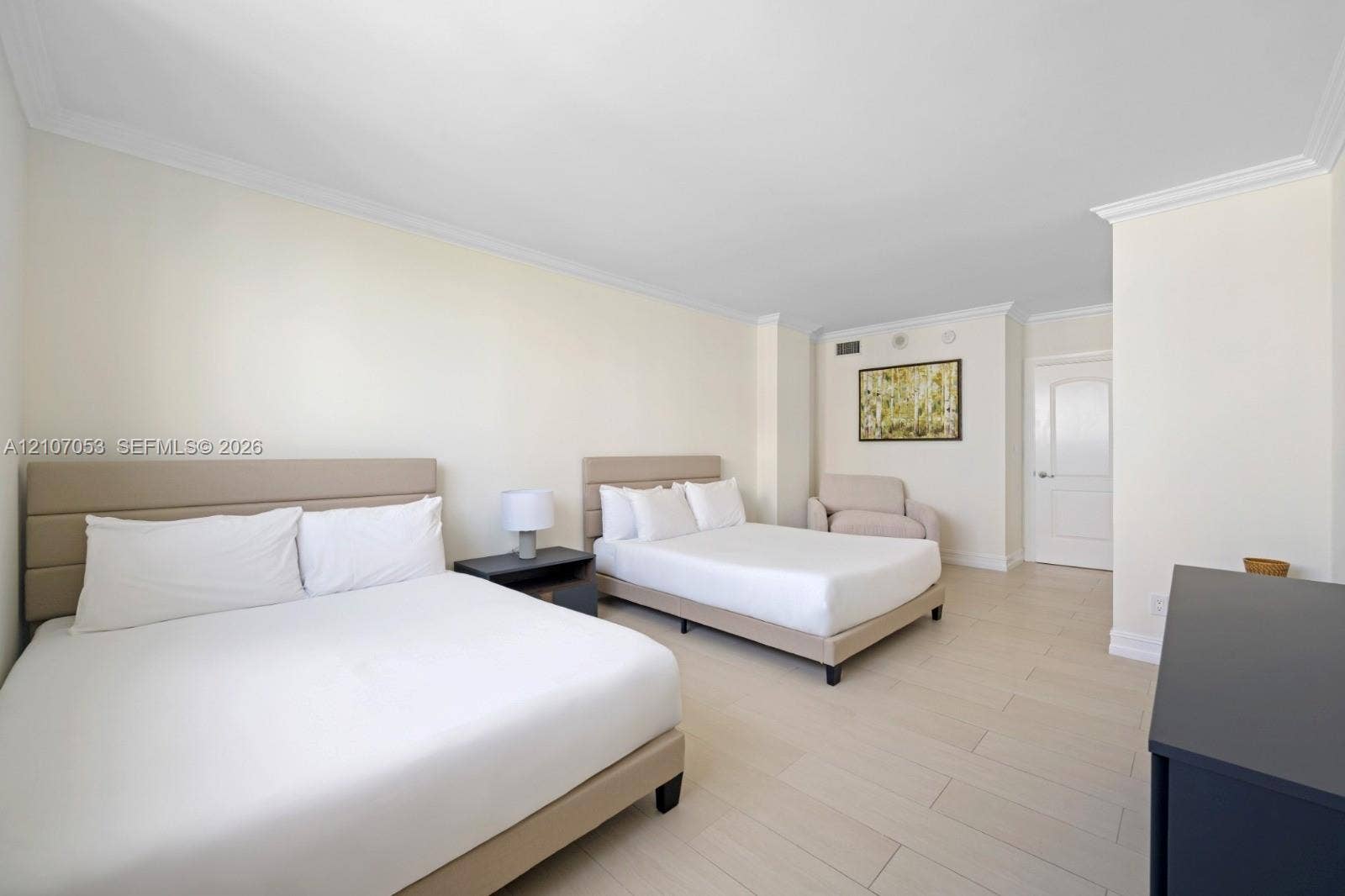 19370 Collins Avenue, #1403, Sunny Isles Beach, FL 33160 Spacious room featuring neutral wall tones, crown molding, and light-toned tile flooring throughout