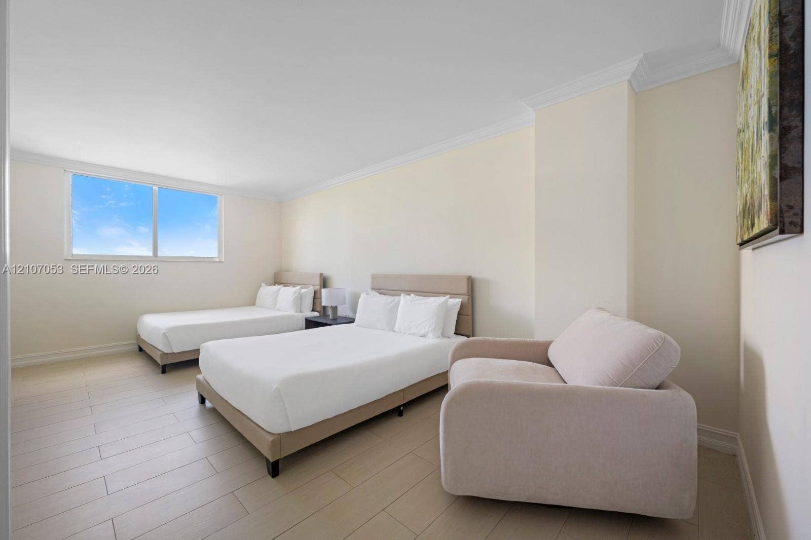 19370 Collins Avenue, #1403, Sunny Isles Beach, FL 33160 Neutral-toned room featuring wood-finish flooring, expansive window, and crown molding