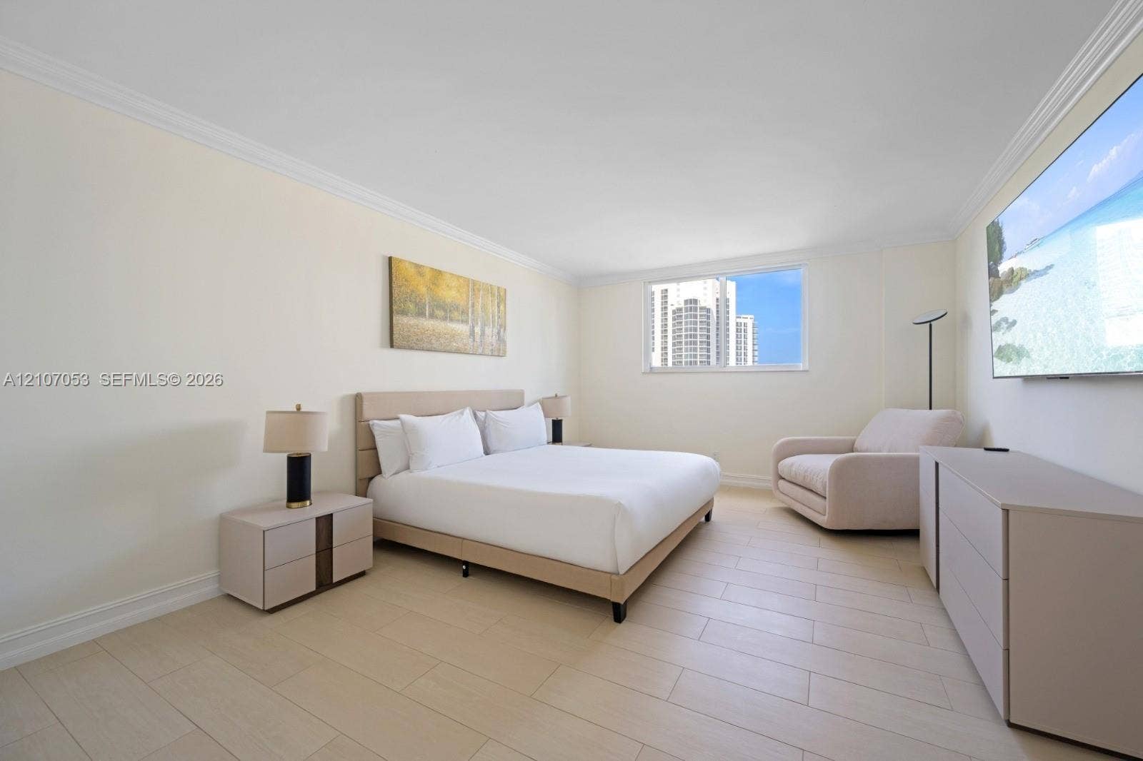 19370 Collins Avenue, #1403, Sunny Isles Beach, FL 33160 Light-toned wood-finish flooring, crown molding, and a large window