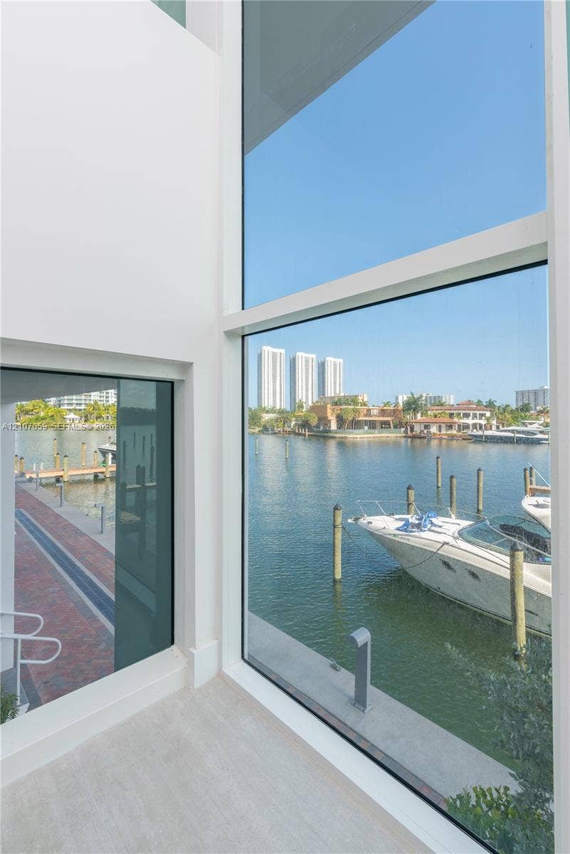 400 Sunny Isles Boulevard, #121, Sunny Isles Beach, FL 33160 Floor-to-ceiling windows, waterfront position, concrete dock, and red brick walkway