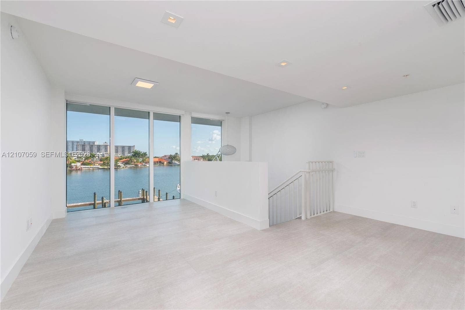 400 Sunny Isles Boulevard, #121, Sunny Isles Beach, FL 33160 Open-concept interior featuring light wood-finish flooring, floor-to-ceiling windows, recessed lighting, and white railings