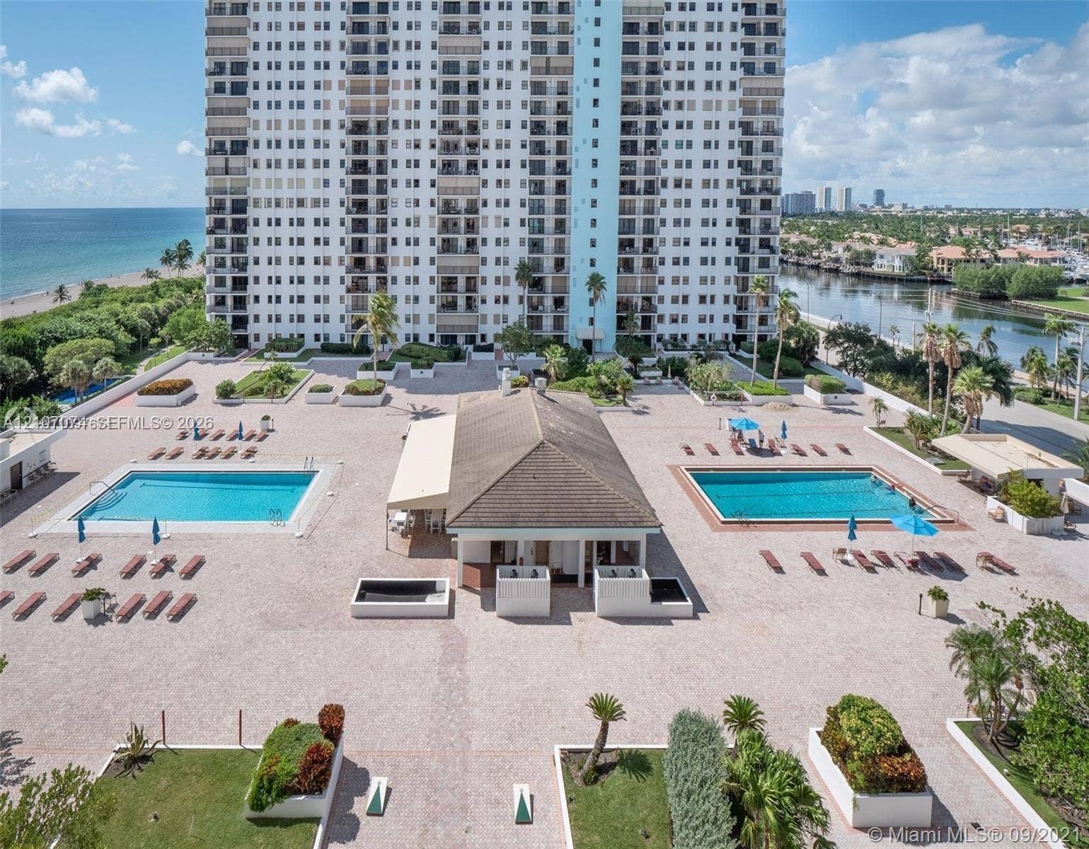 1201 S Ocean Drive, #218N, Hollywood, Hollywood, FL 33019 High-rise property featuring two expansive swimming pools, a central pavilion, paved sundeck, and landscaped garden beds
