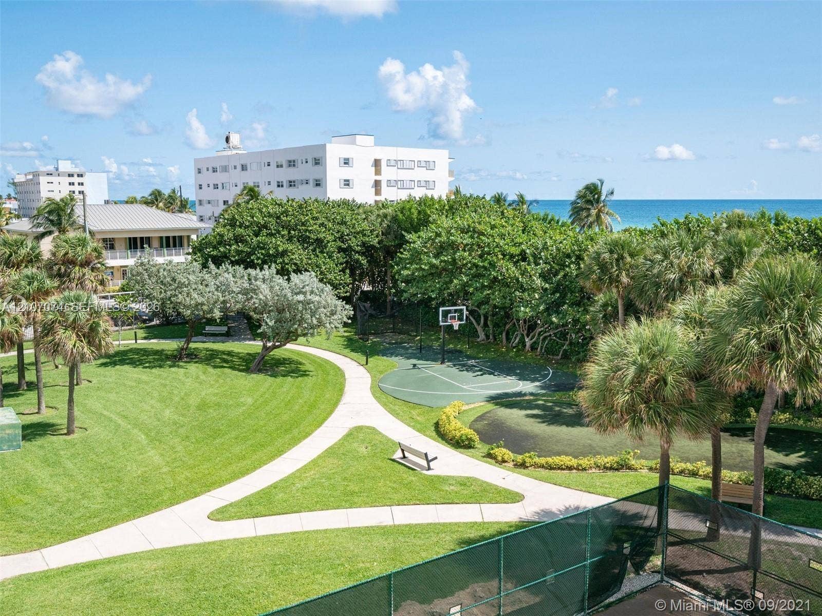 1201 S Ocean Drive, #218N, Hollywood, Hollywood, FL 33019 Expansive grounds featuring a manicured lawn, paved walkways, a dedicated basketball court, and mature landscaping