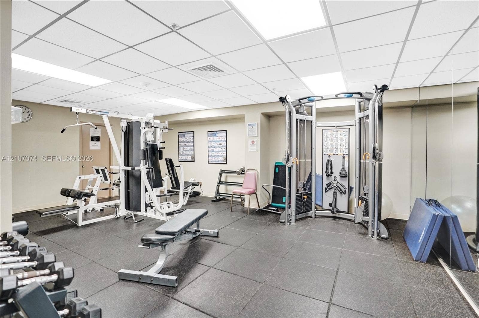 1201 S Ocean Drive, #218N, Hollywood, Hollywood, FL 33019 Fitness area featuring durable rubberized flooring, mirrored wall panels, and drop ceiling with recessed lighting