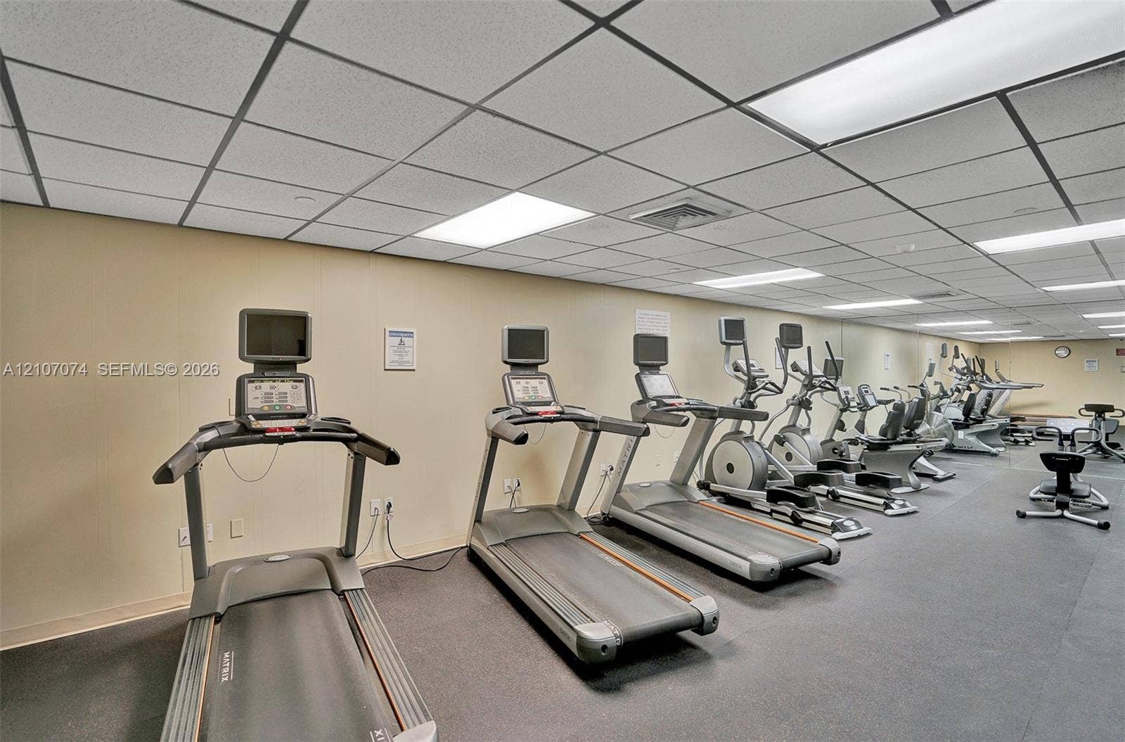 1201 S Ocean Drive, #218N, Hollywood, Hollywood, FL 33019 Fitness facility featuring commercial-grade athletic equipment, rubberized flooring, mirrored wall panels, and drop-ceiling grid lighting