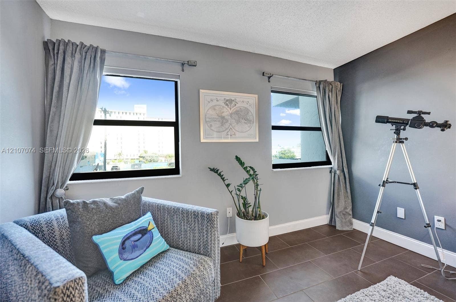 1201 S Ocean Drive, #218N, Hollywood, Hollywood, FL 33019 Interior space featuring dual windows with black frames, tile flooring, and a contrast wall with a matte finish
