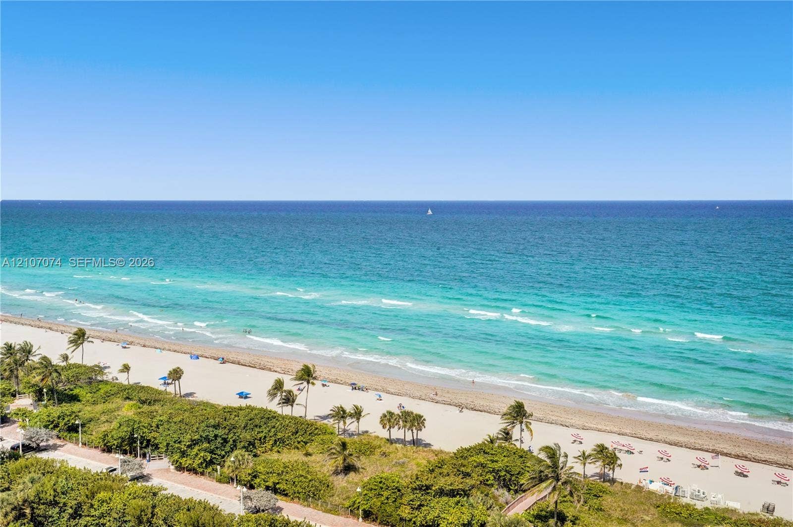 1201 S Ocean Drive, #218N, Hollywood, Hollywood, FL 33019 Oceanfront panorama featuring an expansive sandy beach, turquoise waters, and lush native landscaping