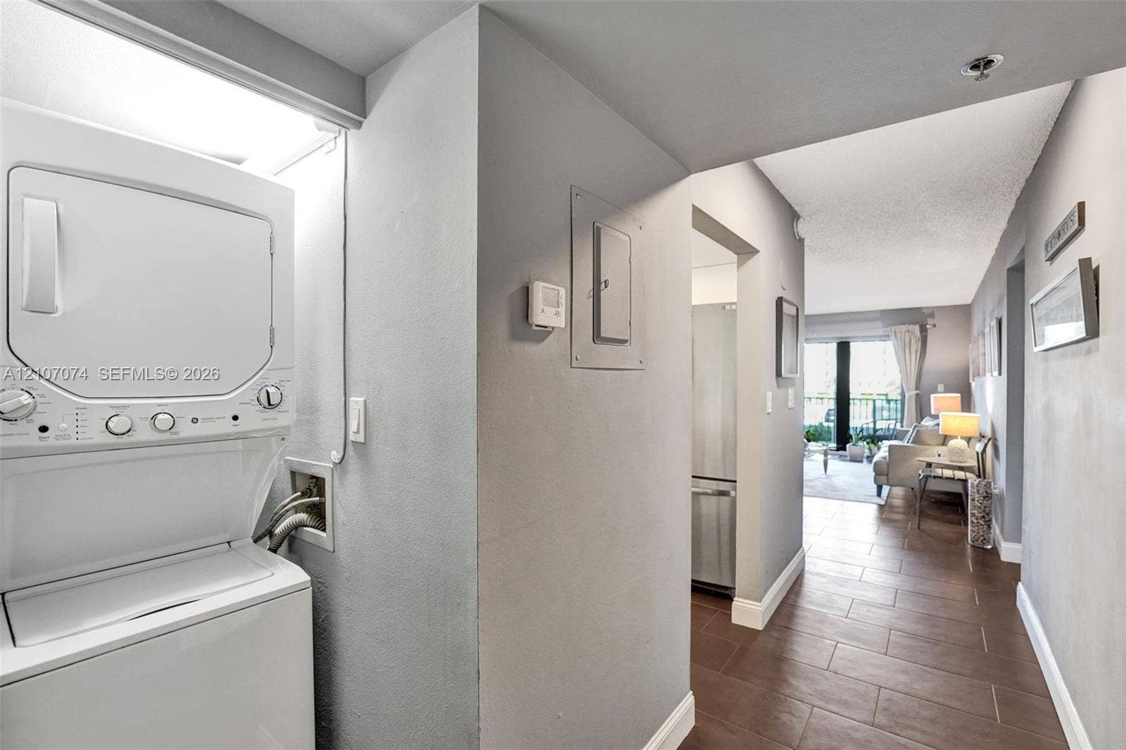 1201 S Ocean Drive, #218N, Hollywood, Hollywood, FL 33019 Stacked laundry unit, tile flooring, and neutral wall tones