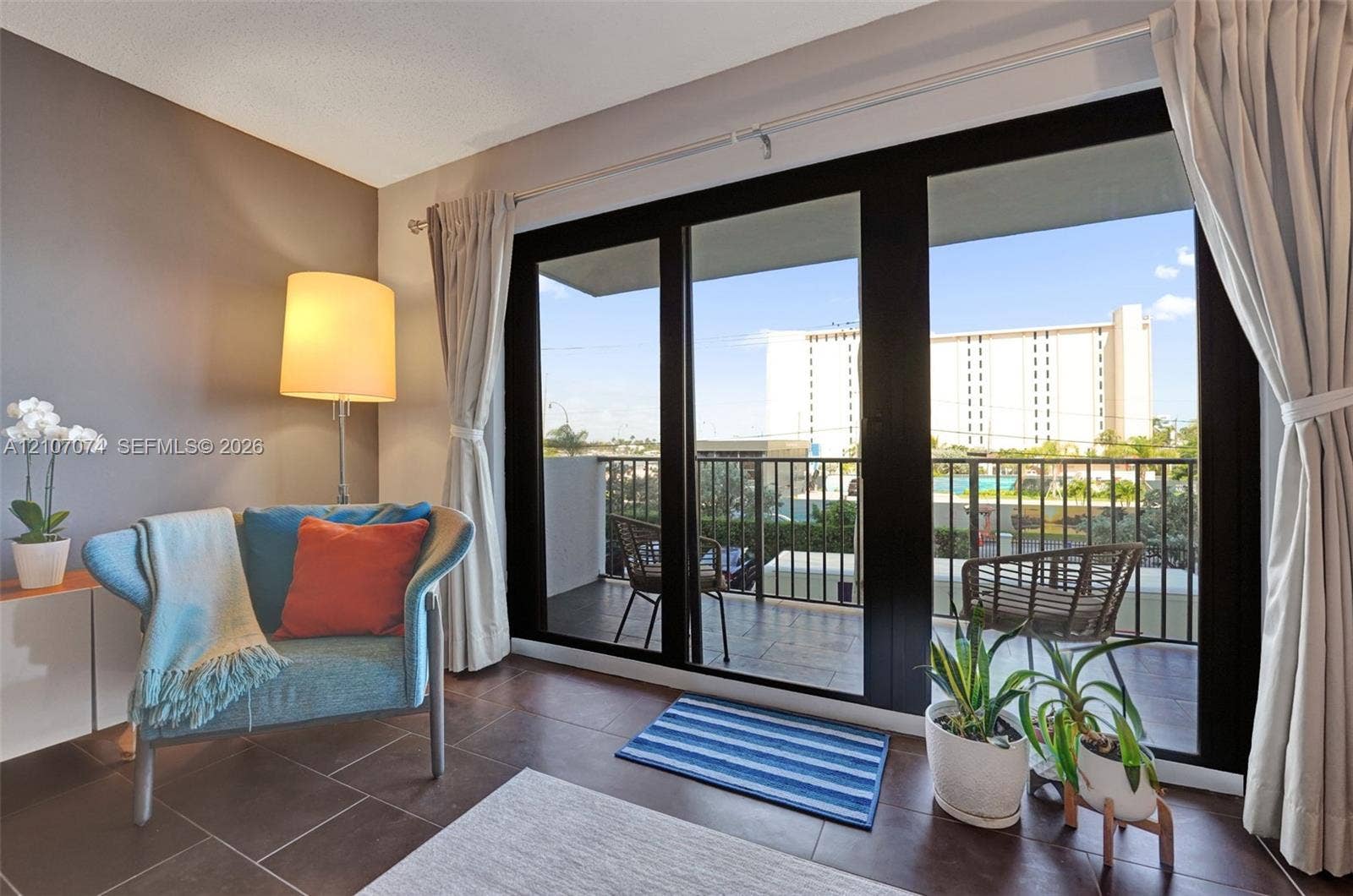 1201 S Ocean Drive, #218N, Hollywood, Hollywood, FL 33019 Large black-framed sliding glass doors opening to a private balcony with metal railings and tile flooring