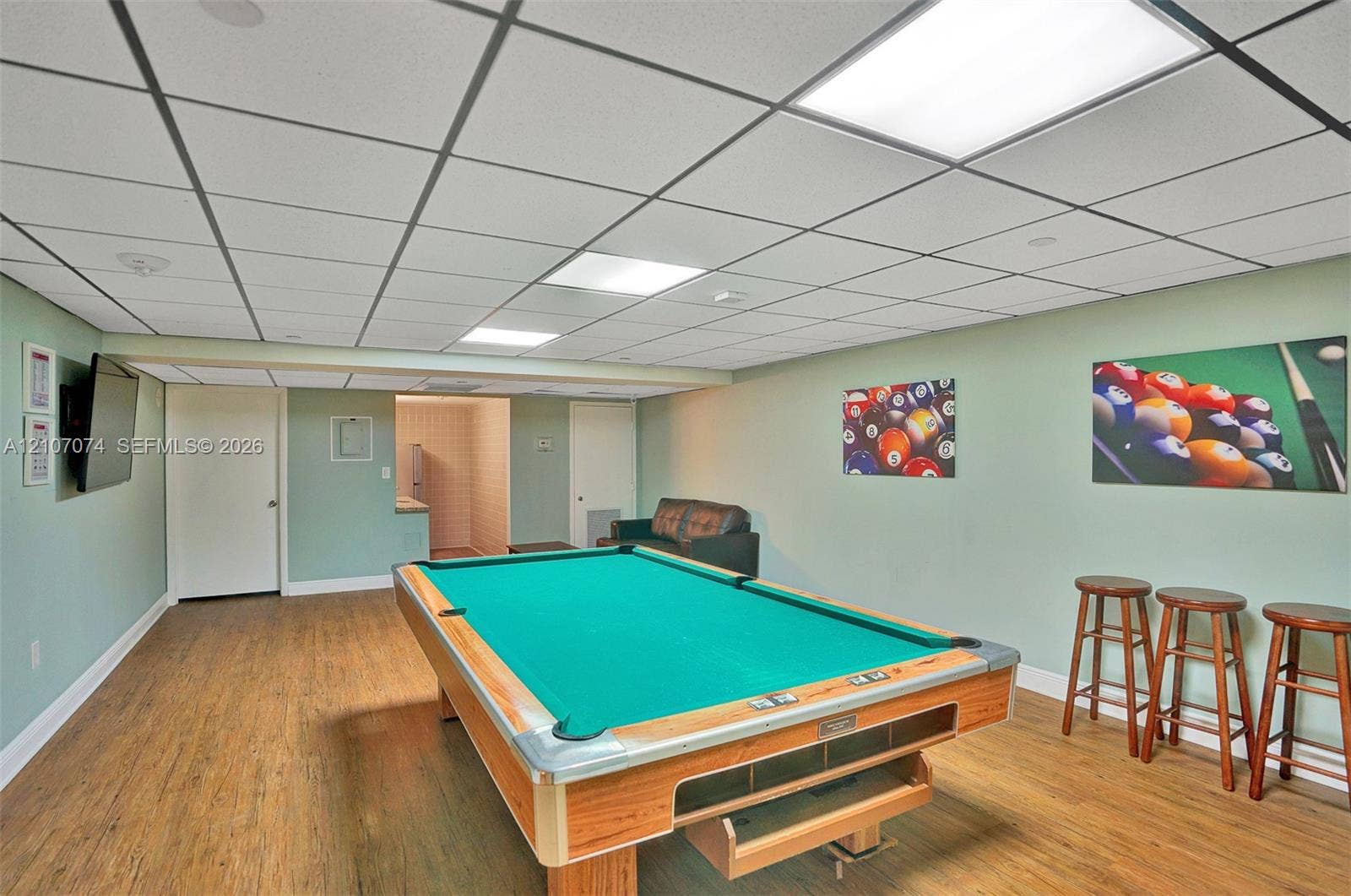 1201 S Ocean Drive, #218N, Hollywood, Hollywood, FL 33019 Rec room featuring a suspended drop ceiling, recessed panel lighting, and wood-finish flooring