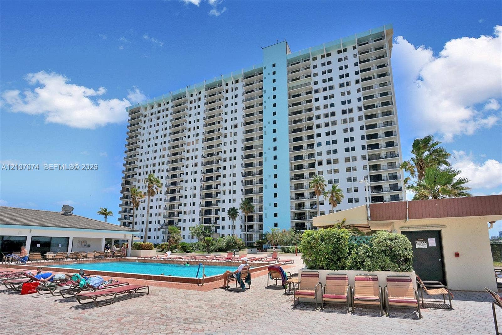 1201 S Ocean Drive, #218N, Hollywood, Hollywood, FL 33019 High-rise building featuring private balconies, an outdoor swimming pool, and an expansive paved deck area