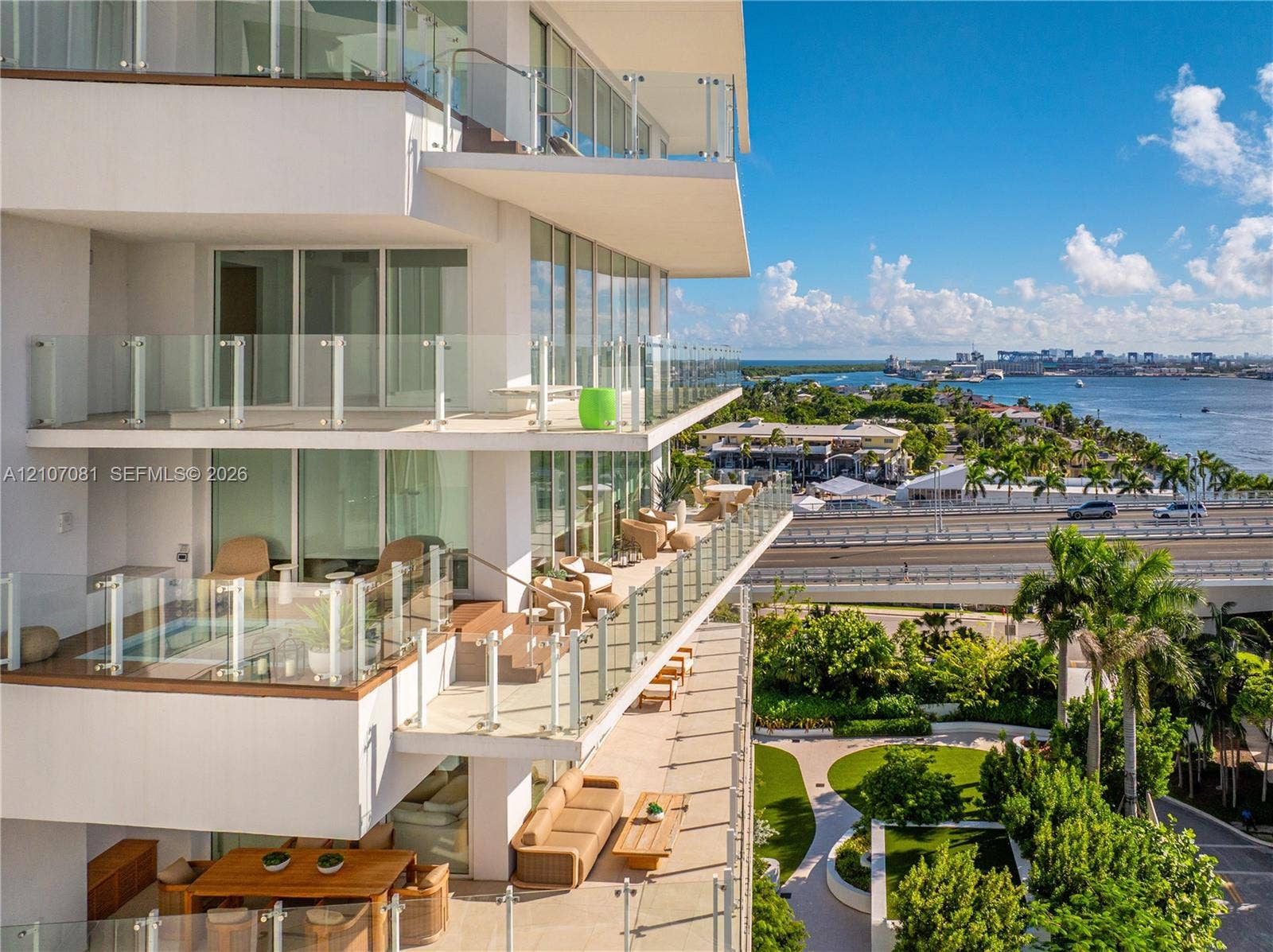 Multi-level exterior balconies featuring glass railings and floor-to-ceiling windows