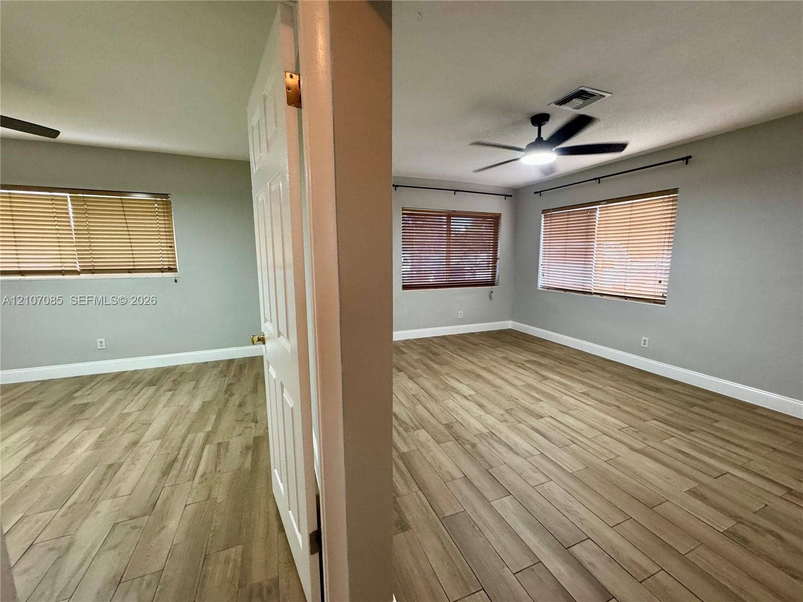 2641 SW 13th Avenue, #1, Fort Lauderdale, Fort Lauderdale, FL 33315 Interior spaces featuring wood-finish flooring, neutral wall paint, multi-paneled doors, and ceiling fans with integrated lighting