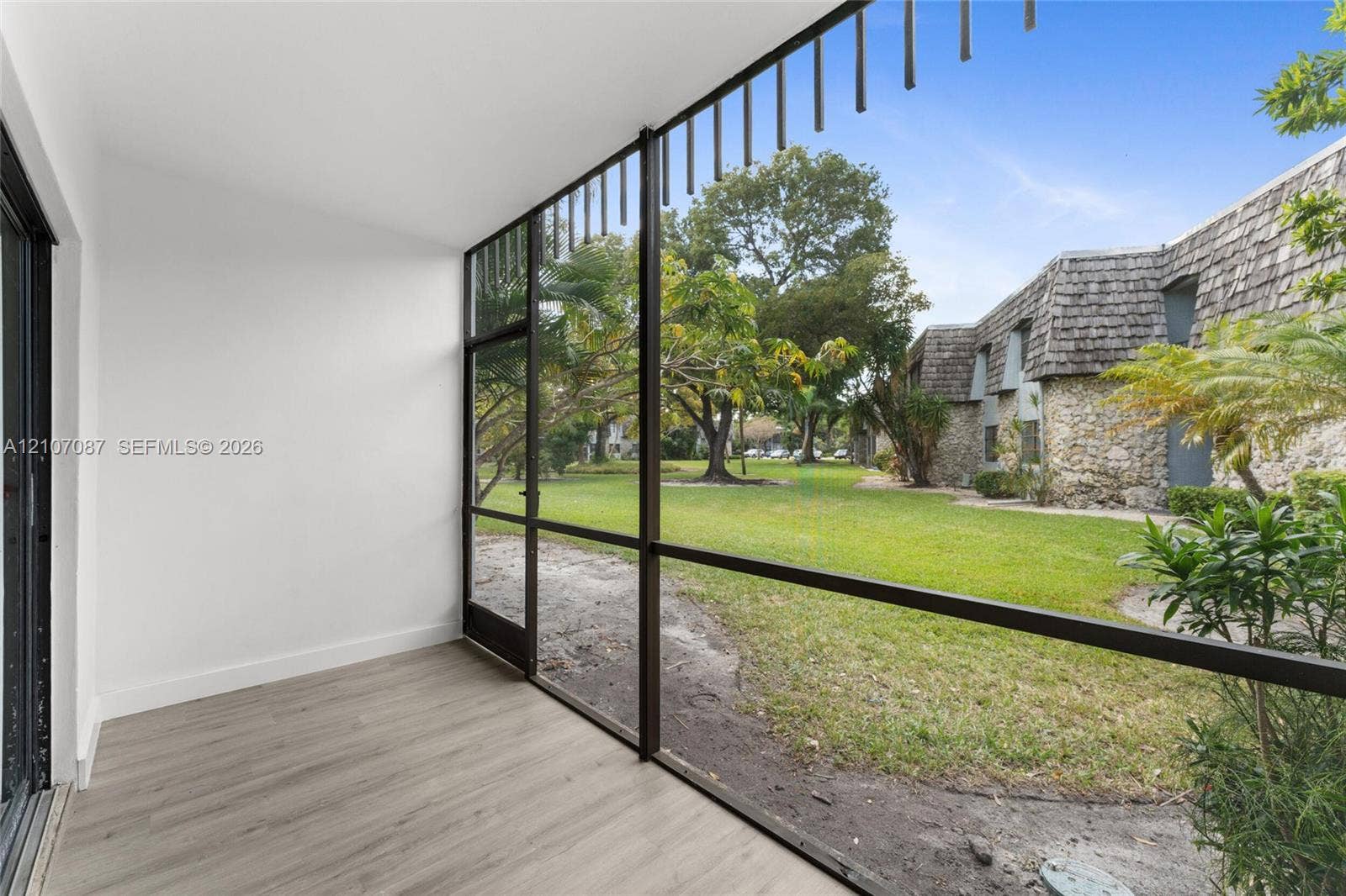 Enclosed porch featuring screen paneling, wood-finish flooring, and expansive glass exposure