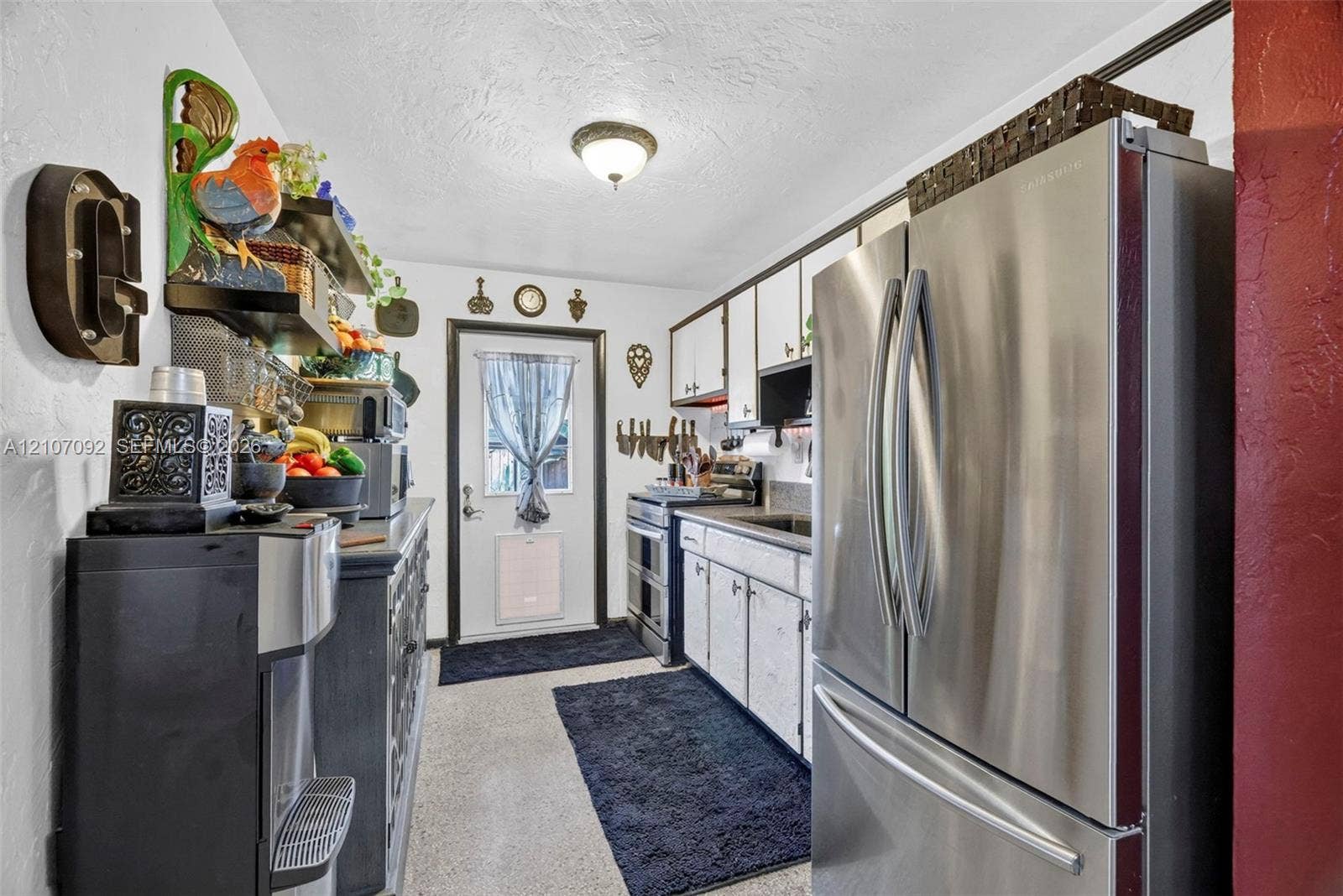 2864 NE 12th Terrace, Pompano Beach, FL 33064 Kitchen featuring white cabinetry, stainless steel French-door refrigerator, integrated range, and flush-mount ceiling lighting