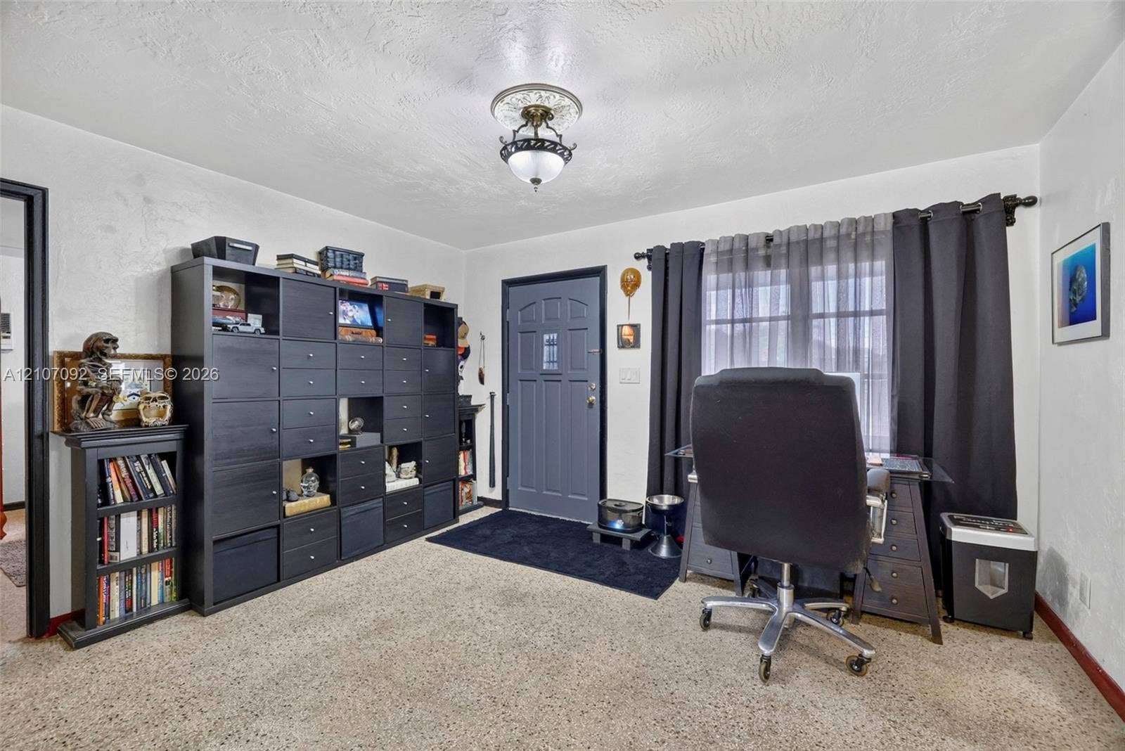 2864 NE 12th Terrace, Pompano Beach, FL 33064 Textured ceiling featuring a decorative medallion with a multi-light flush mount fixture and a paneled entry door with an integrated window