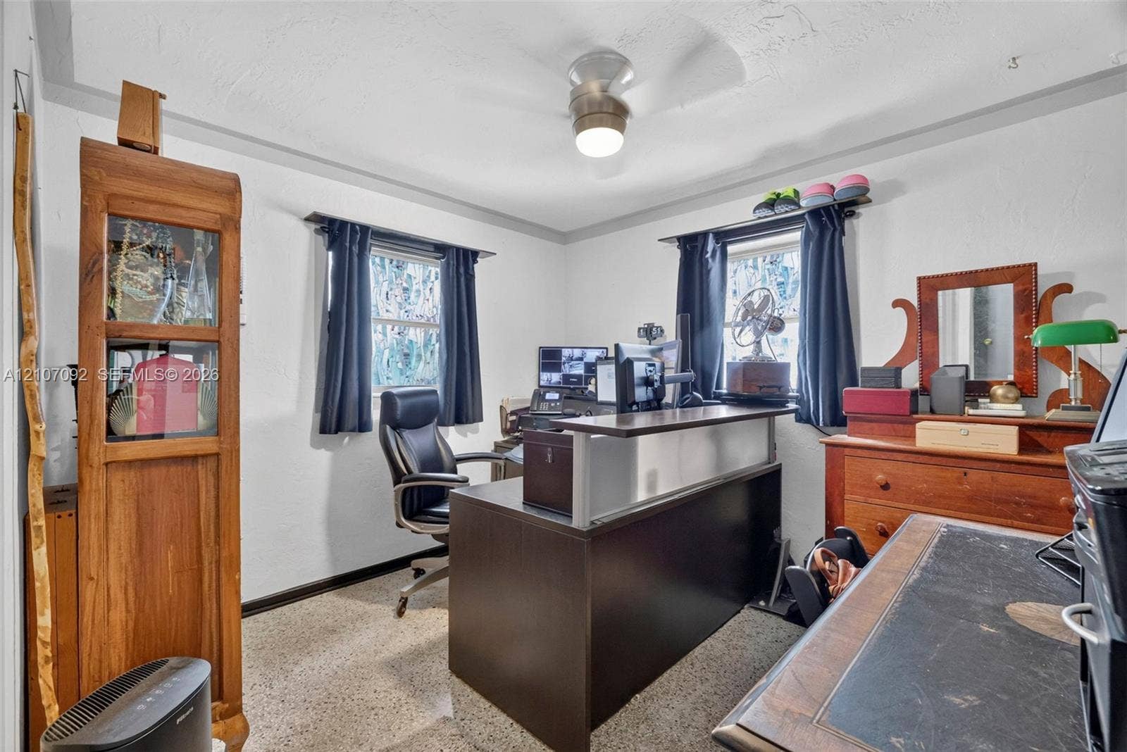 2864 NE 12th Terrace, Pompano Beach, FL 33064 Neutral-toned walls, ceiling-mounted light fixture with fan, and multi-paned windows featuring dark-toned window coverings