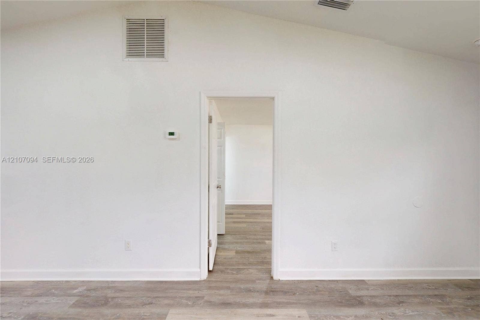 1131 SW London Lane, Port St Lucie, FL 34953 Vaulted ceiling featuring wood-finish flooring throughout