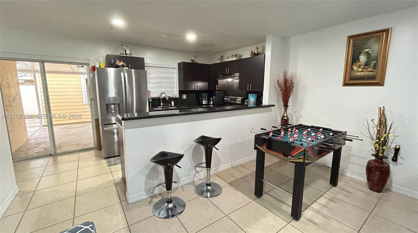 16259 SW 306th Street, #0, Homestead, Homestead, FL 33033 Kitchen featuring dark cabinetry, stainless steel refrigerator, stone-surface breakfast bar, recessed lighting, and ceramic tile flooring
